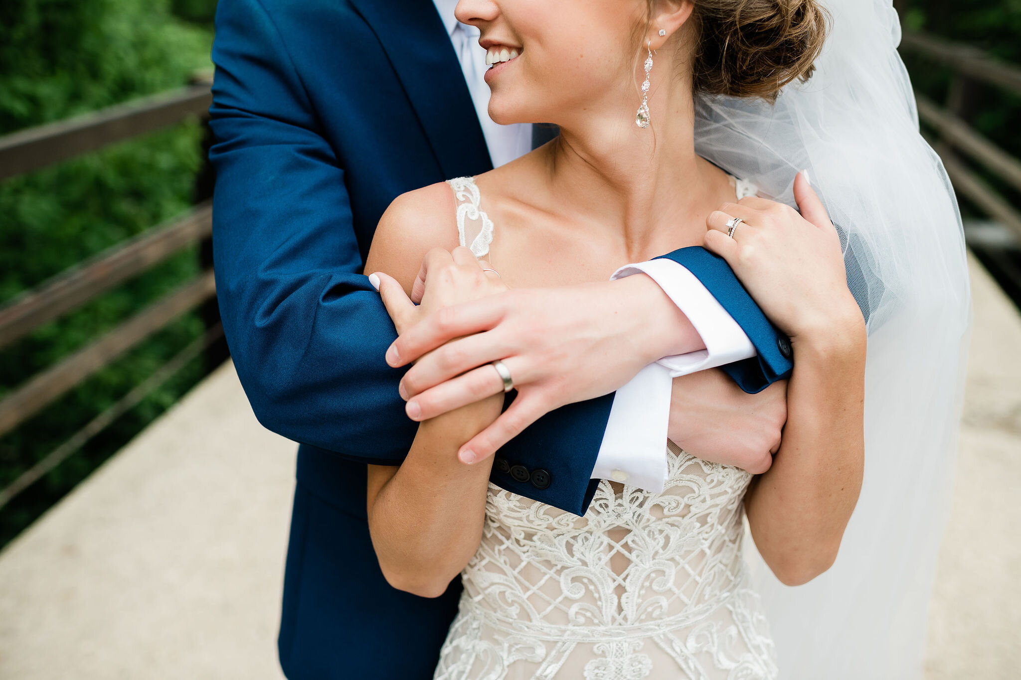 Groom wraps his arms around bride