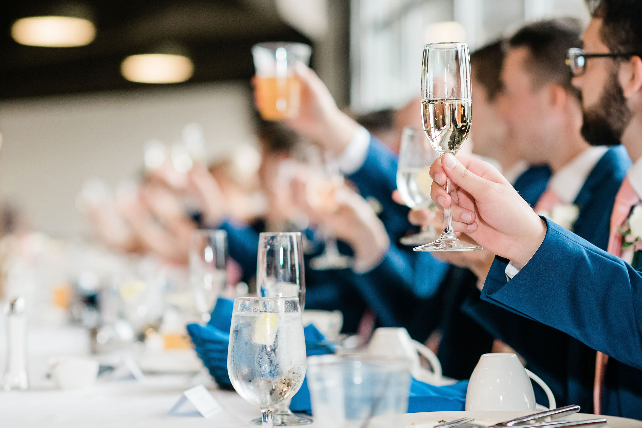 Wedding party raises their glasses for a toast