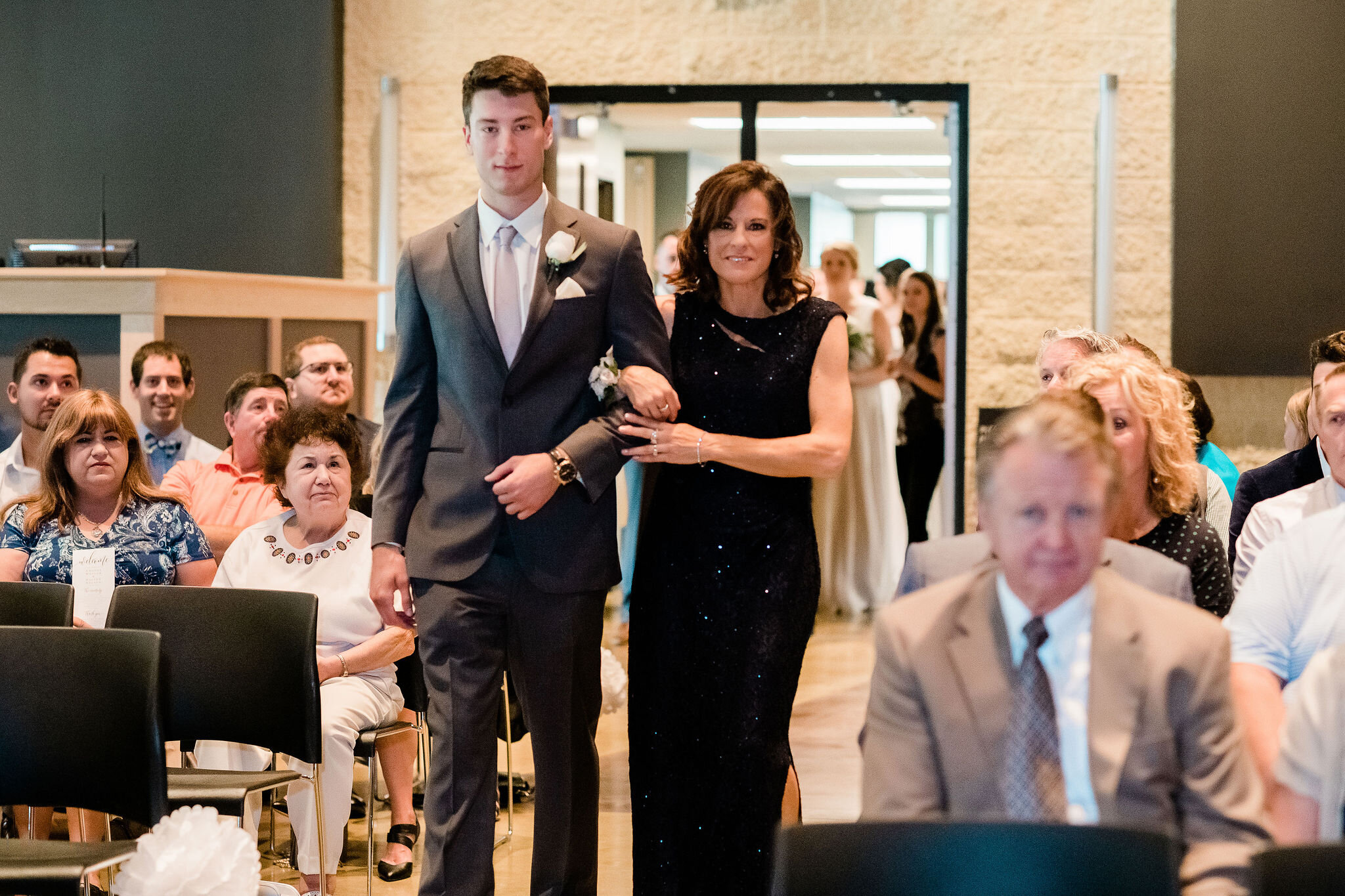 Usher walking mother of the bride down the aisle