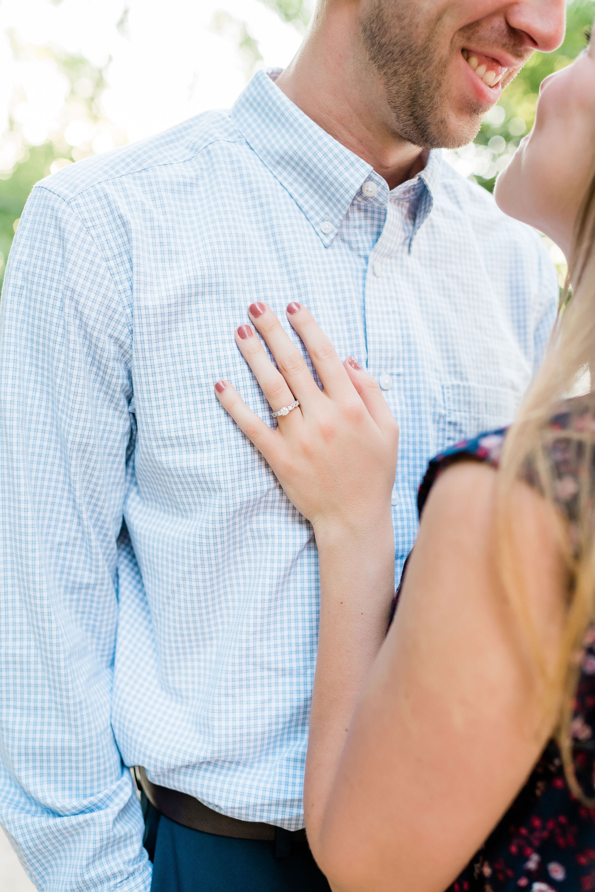 Woman's hand on her fiancé's chest