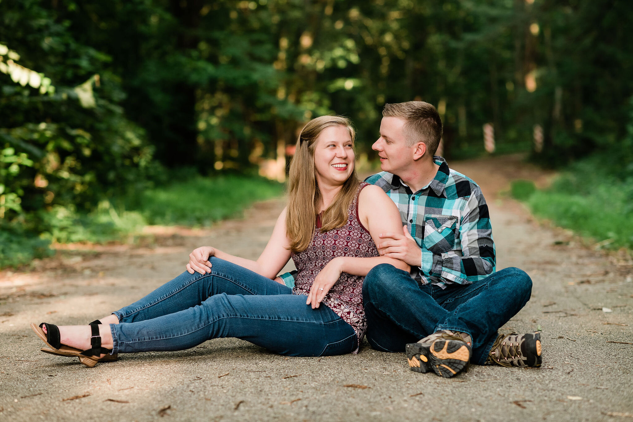 Engaged couple sitting on a path