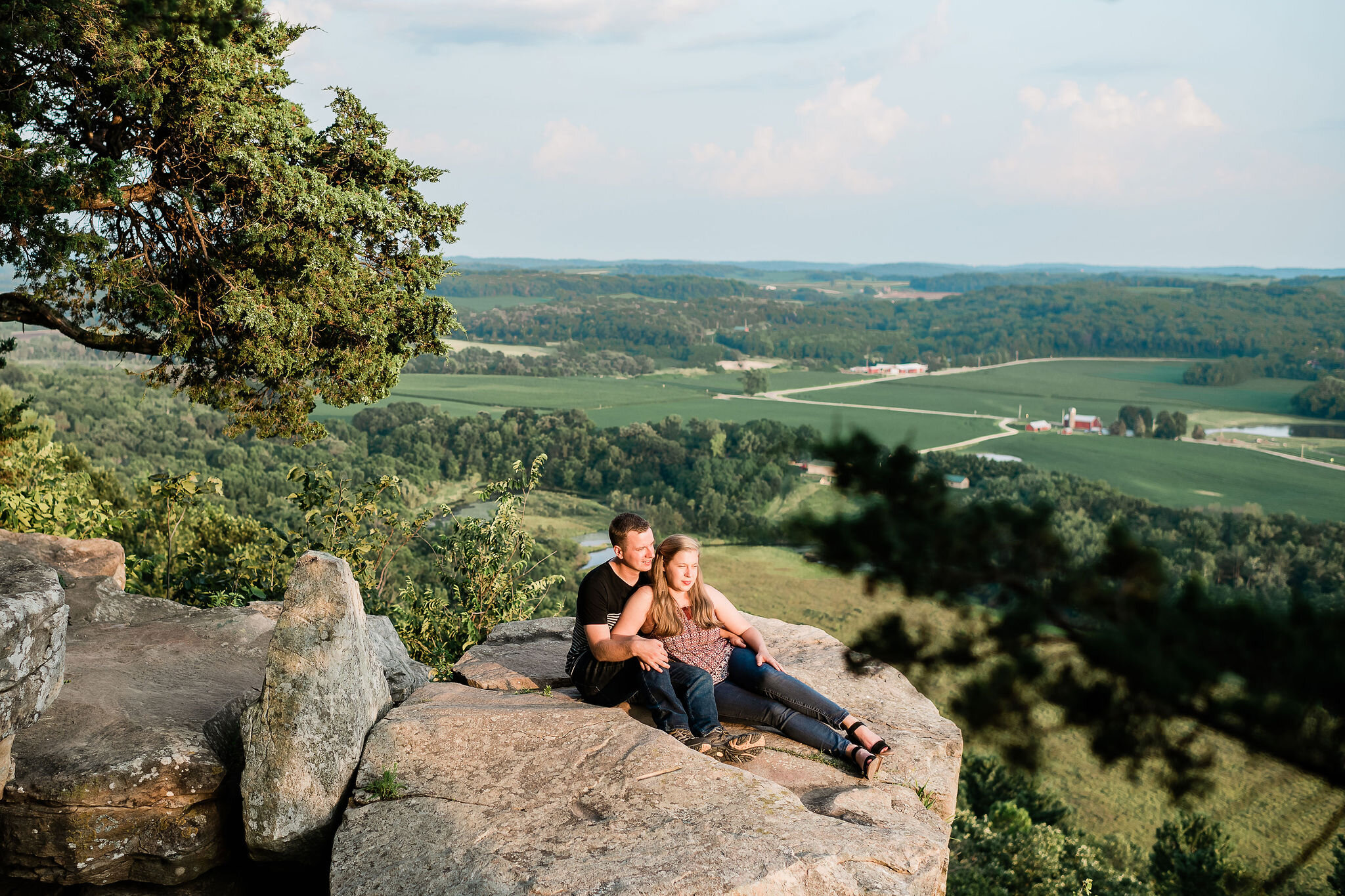 Engaged couple at the top of Gibraltar Rock State Natural Area in Lodi, WI