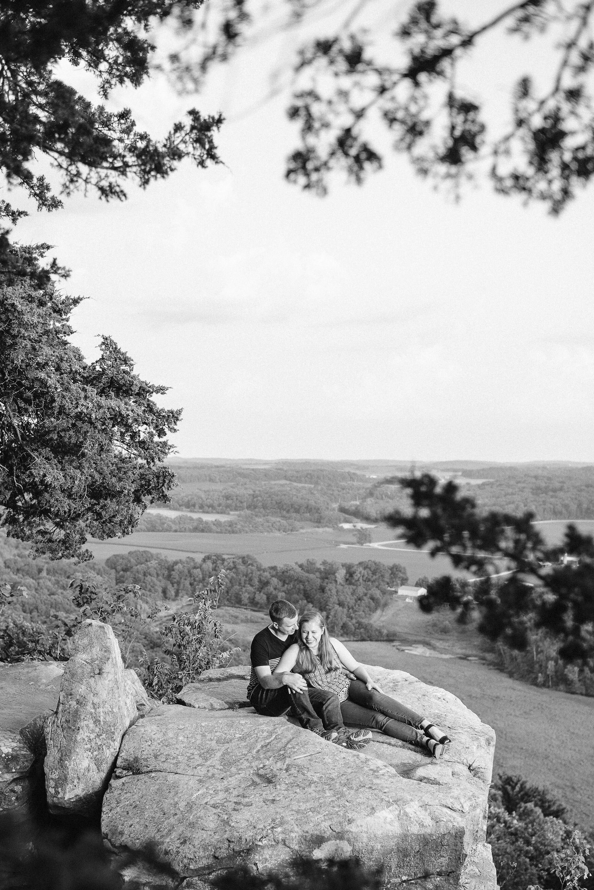 Engaged couple at the top of Gibraltar Rock State Natural Area in Lodi, WI