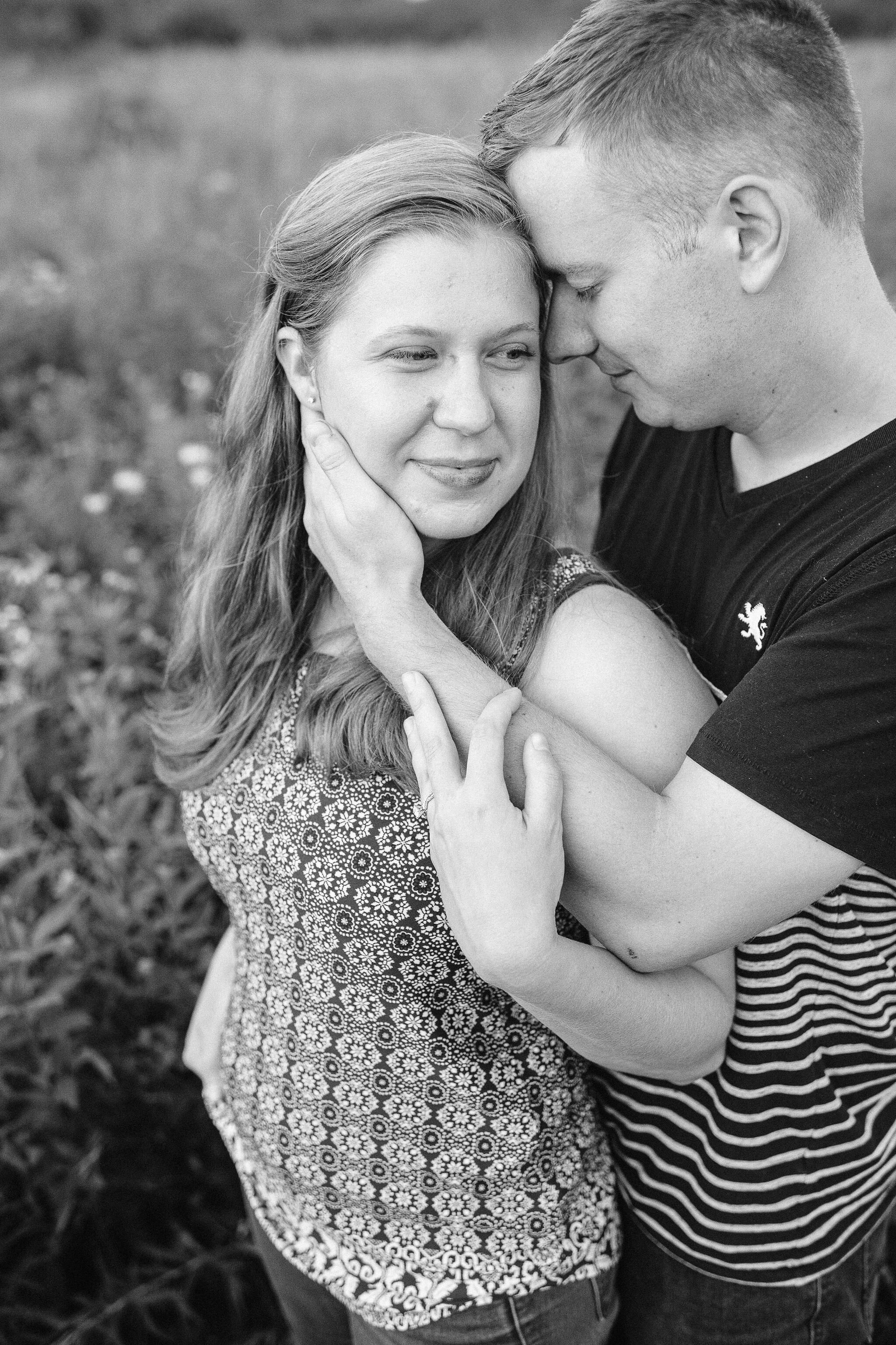 Engaged couple holding each other