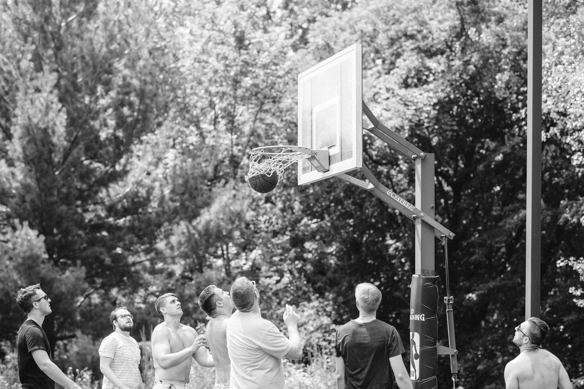 Groom and groomsmen playing basketball
