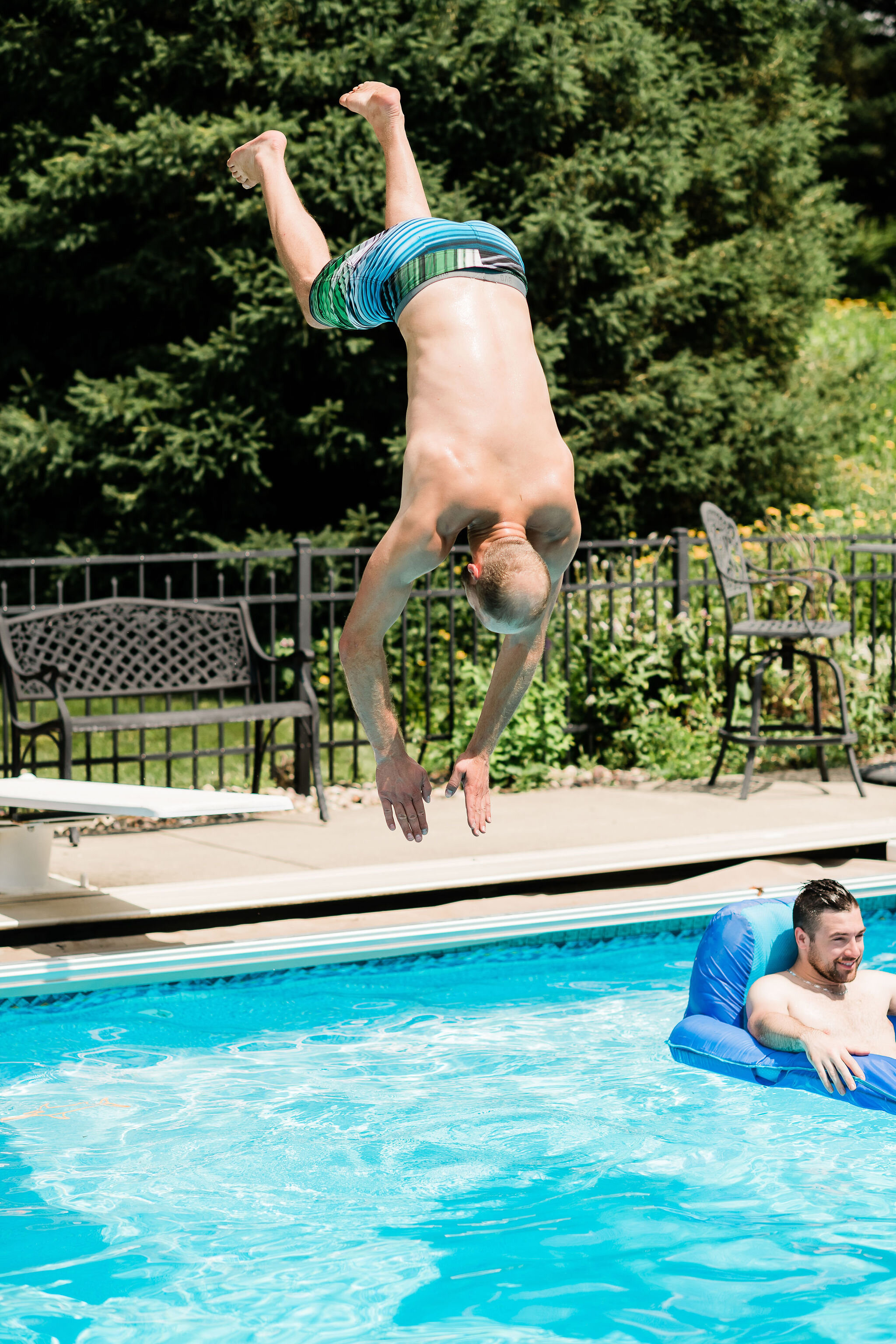 Groomsman diving into a pool