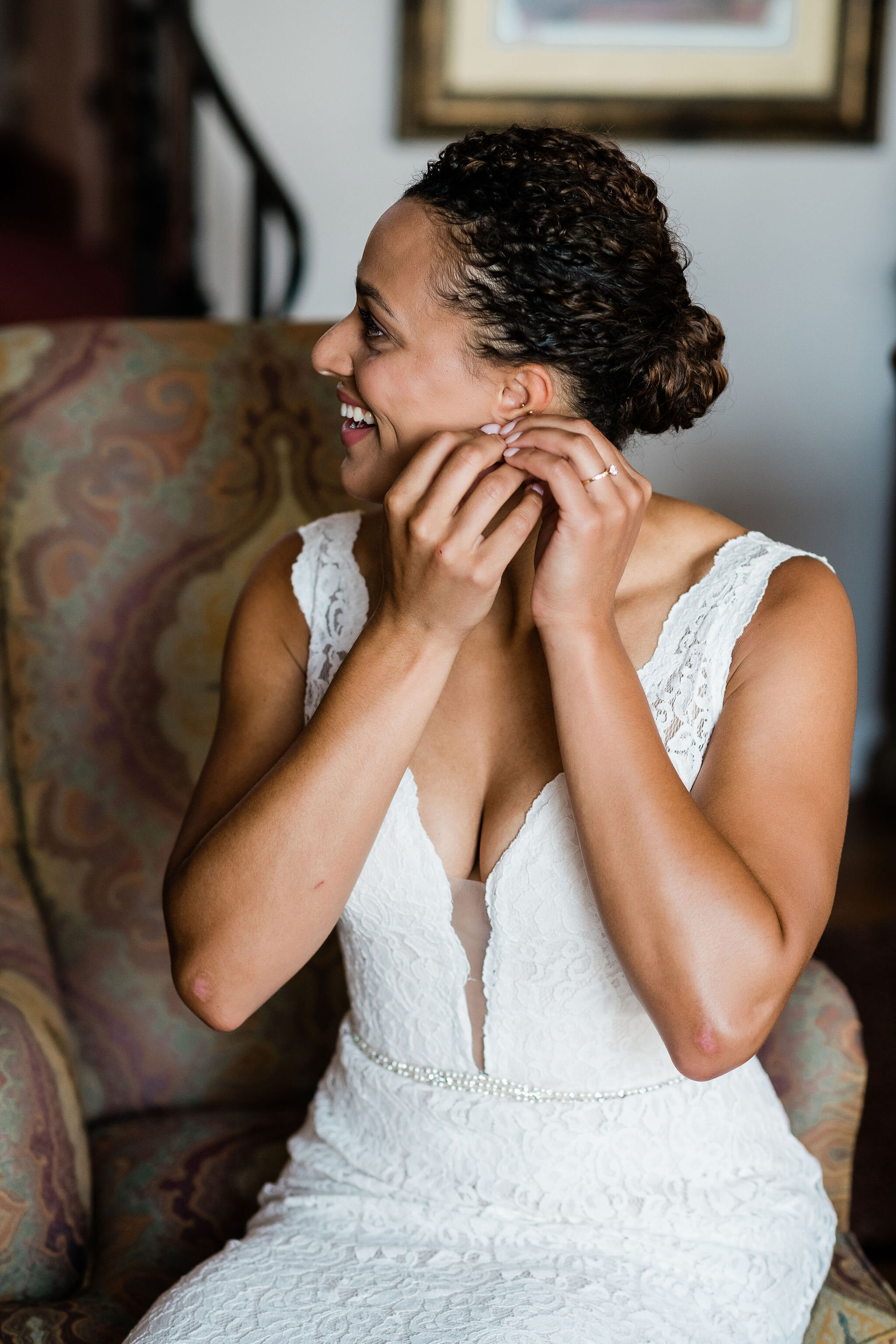 Bride putting her earrings in