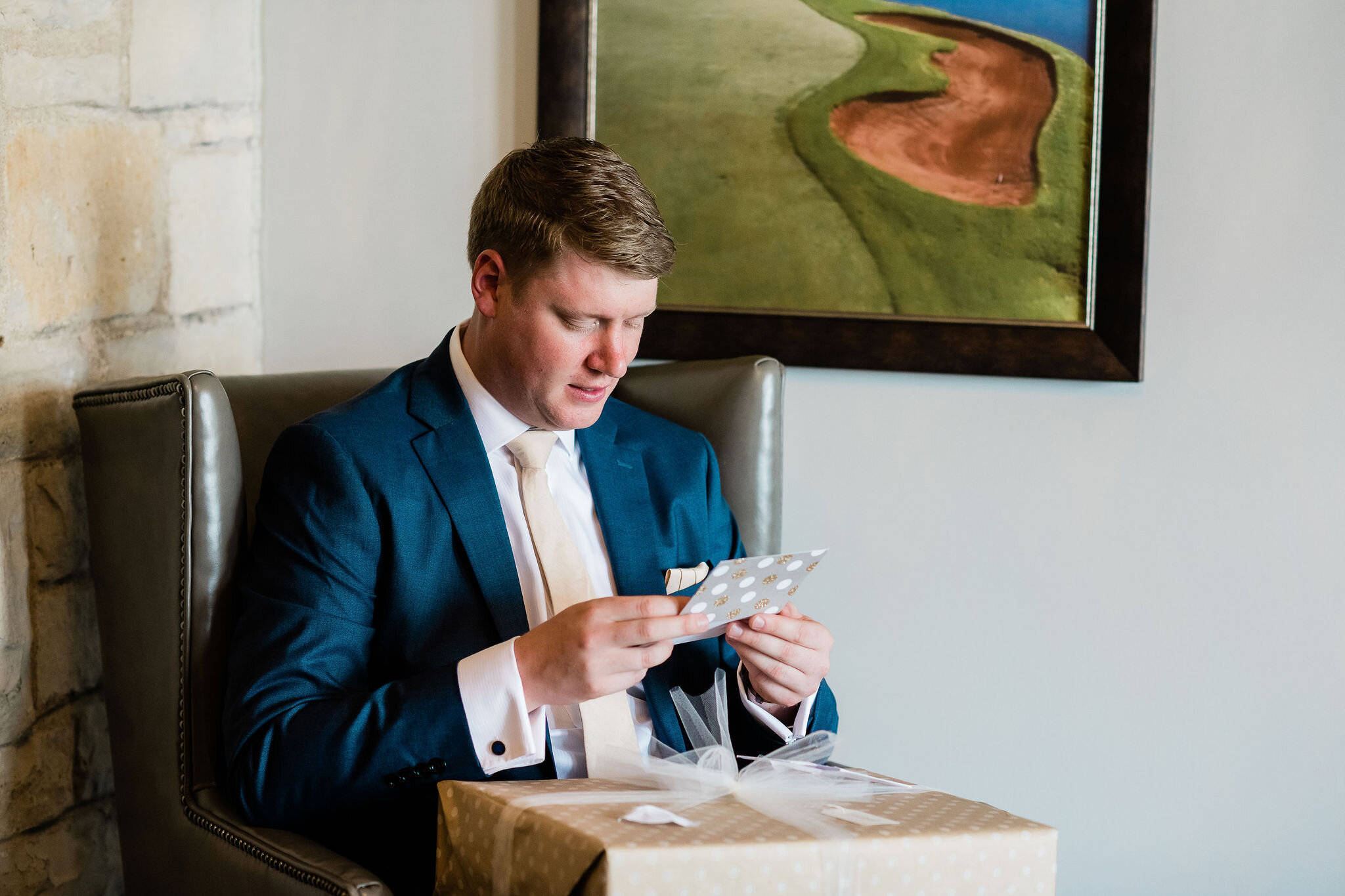 Groom reading a card from the bride