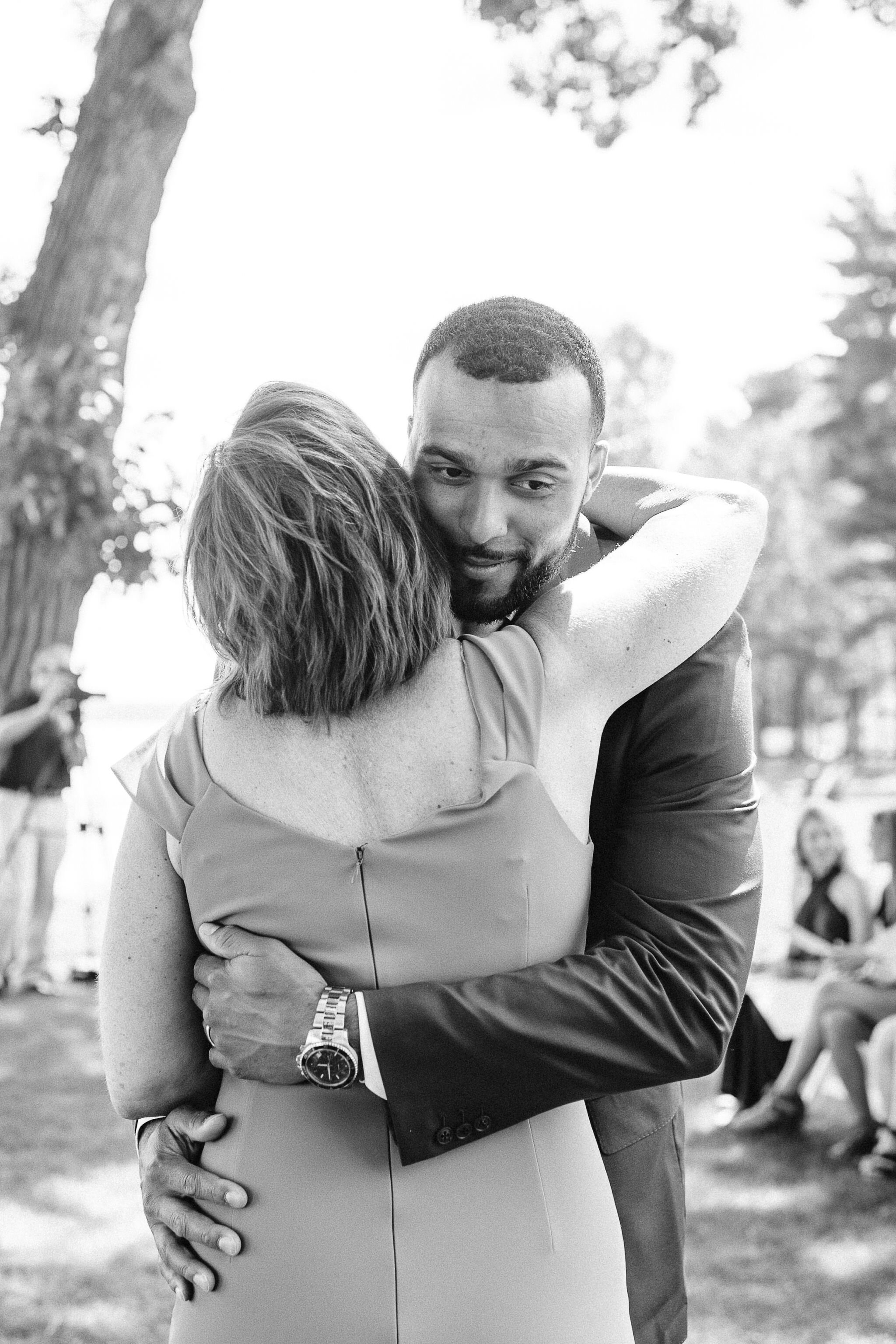 Mother of the bride hugging her son