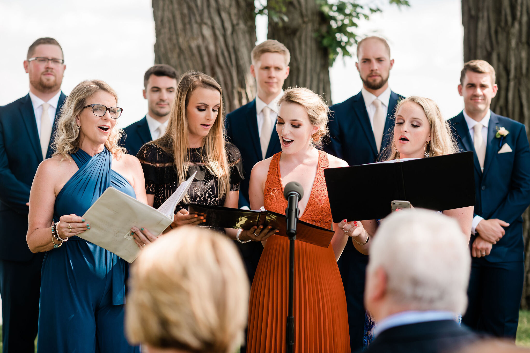 Wedding guests singing at the ceremony