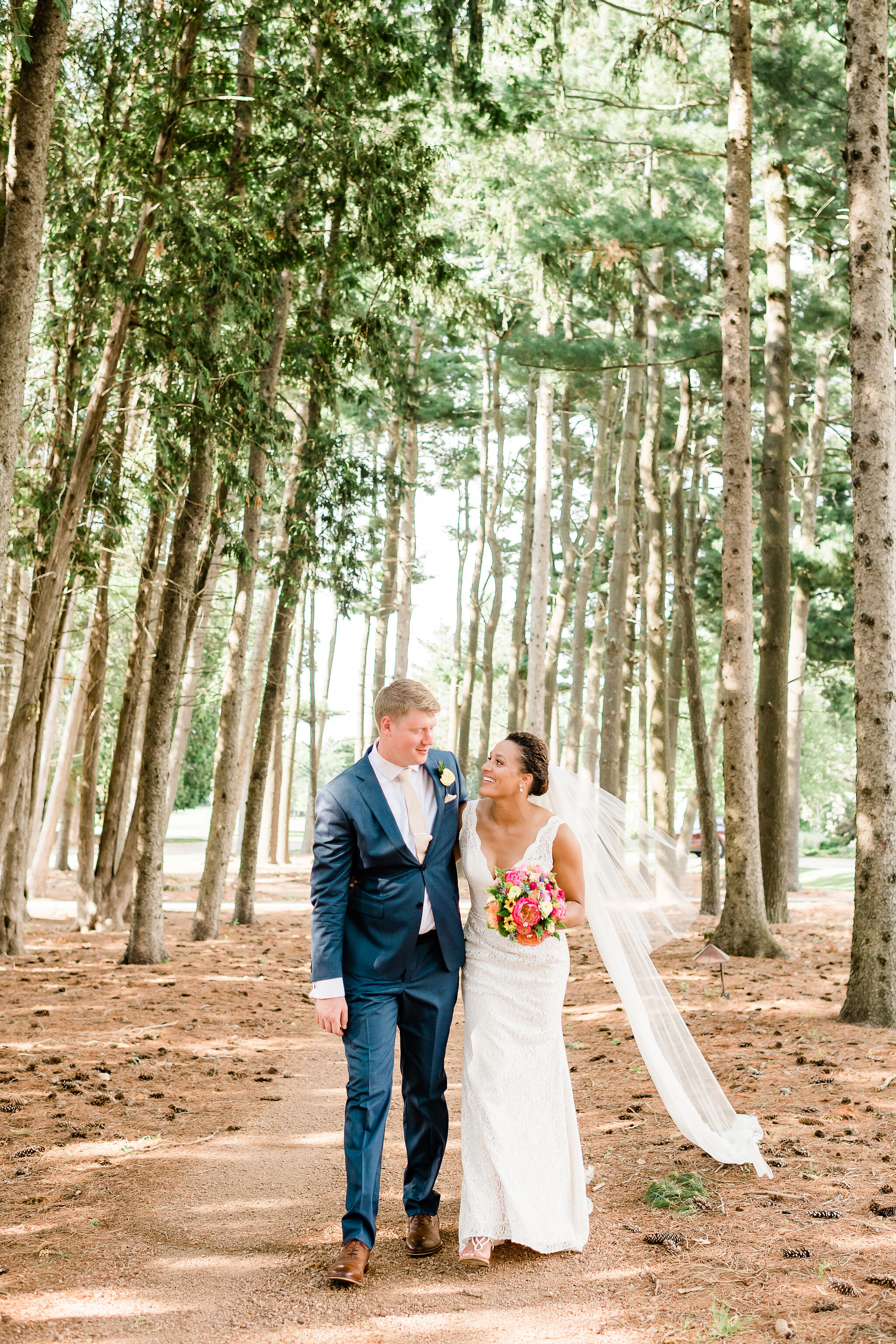 Bride and groom walking in the woods