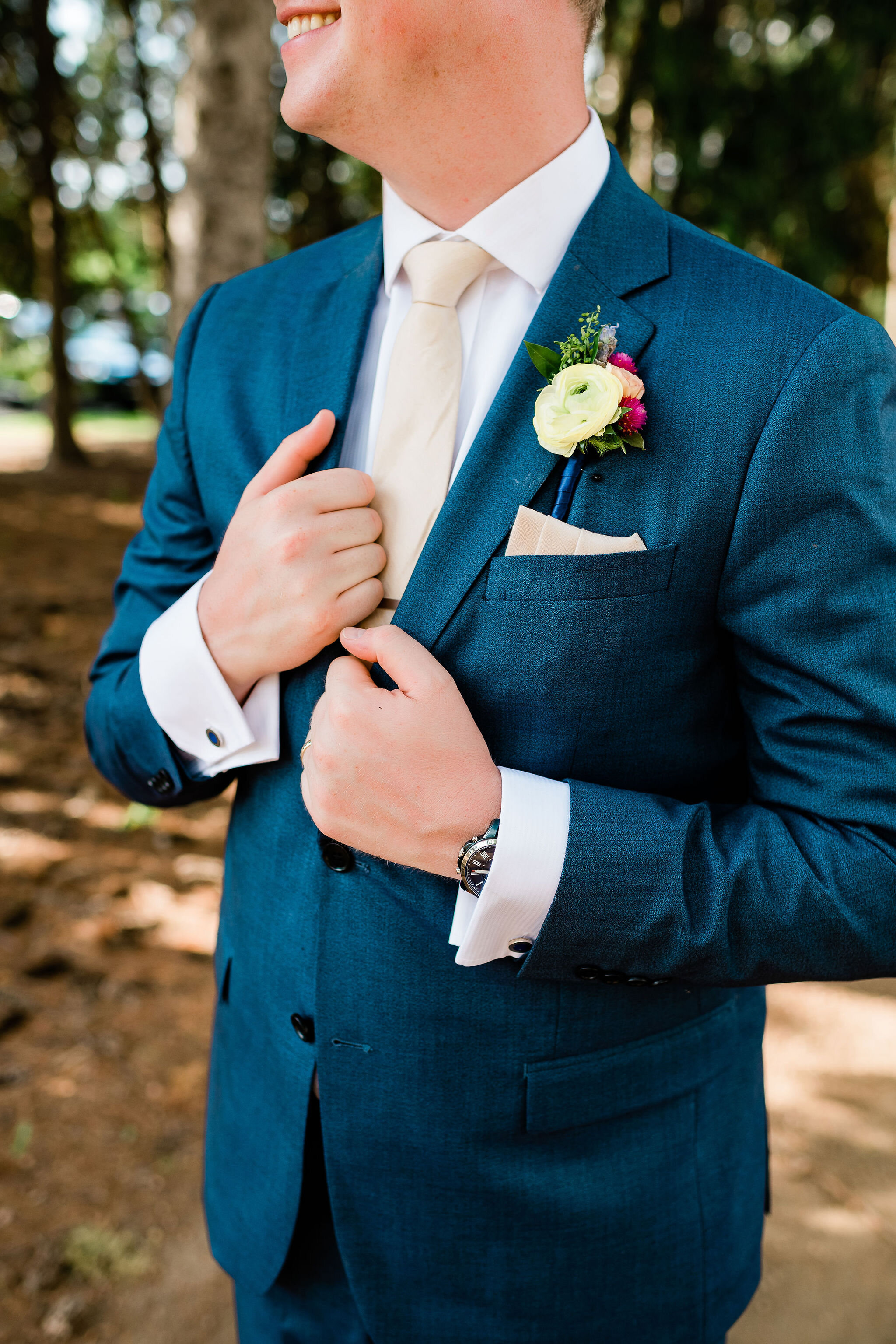 Groom holding his suit jacket