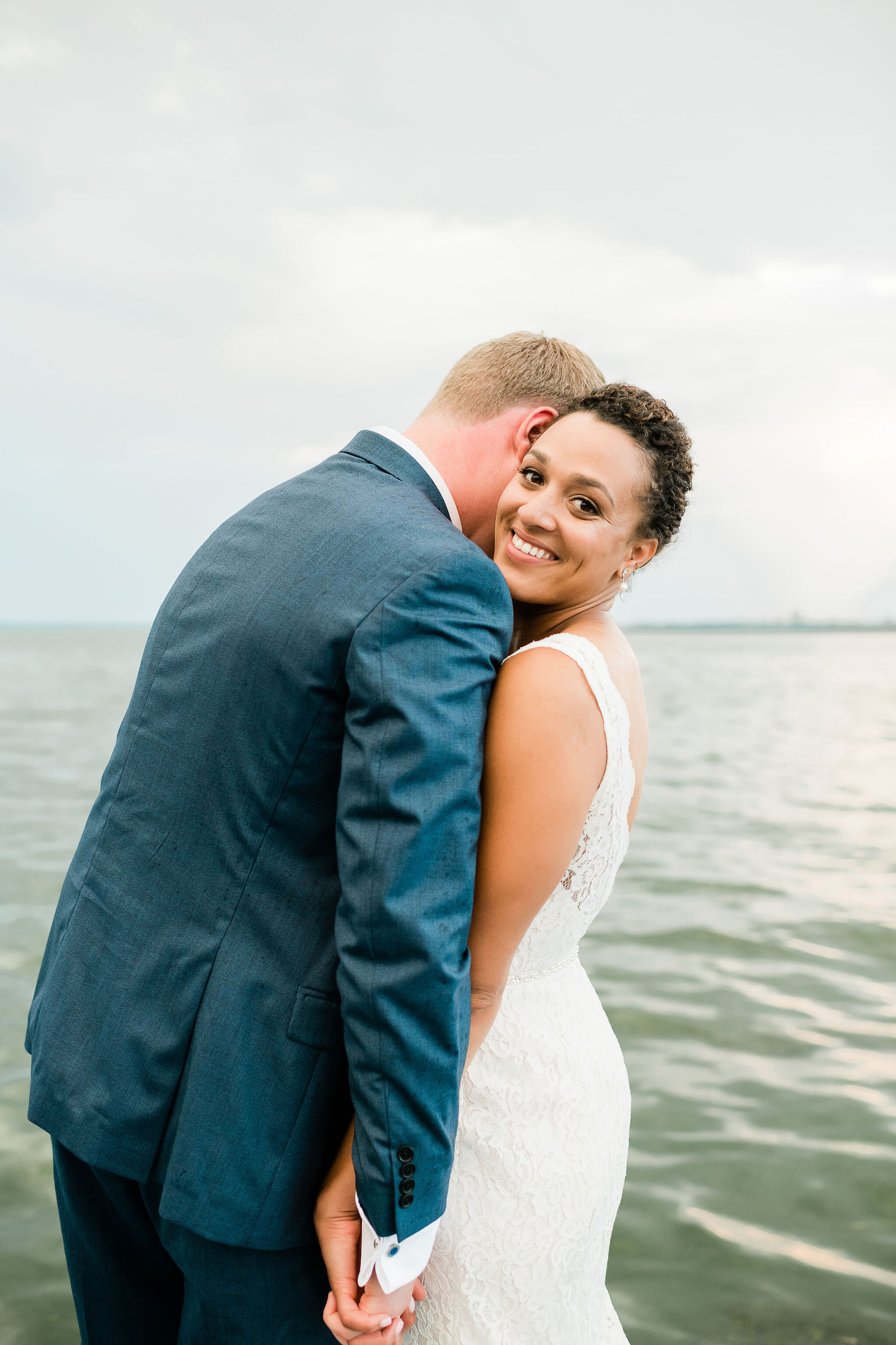 Groom whispering into bride's ear