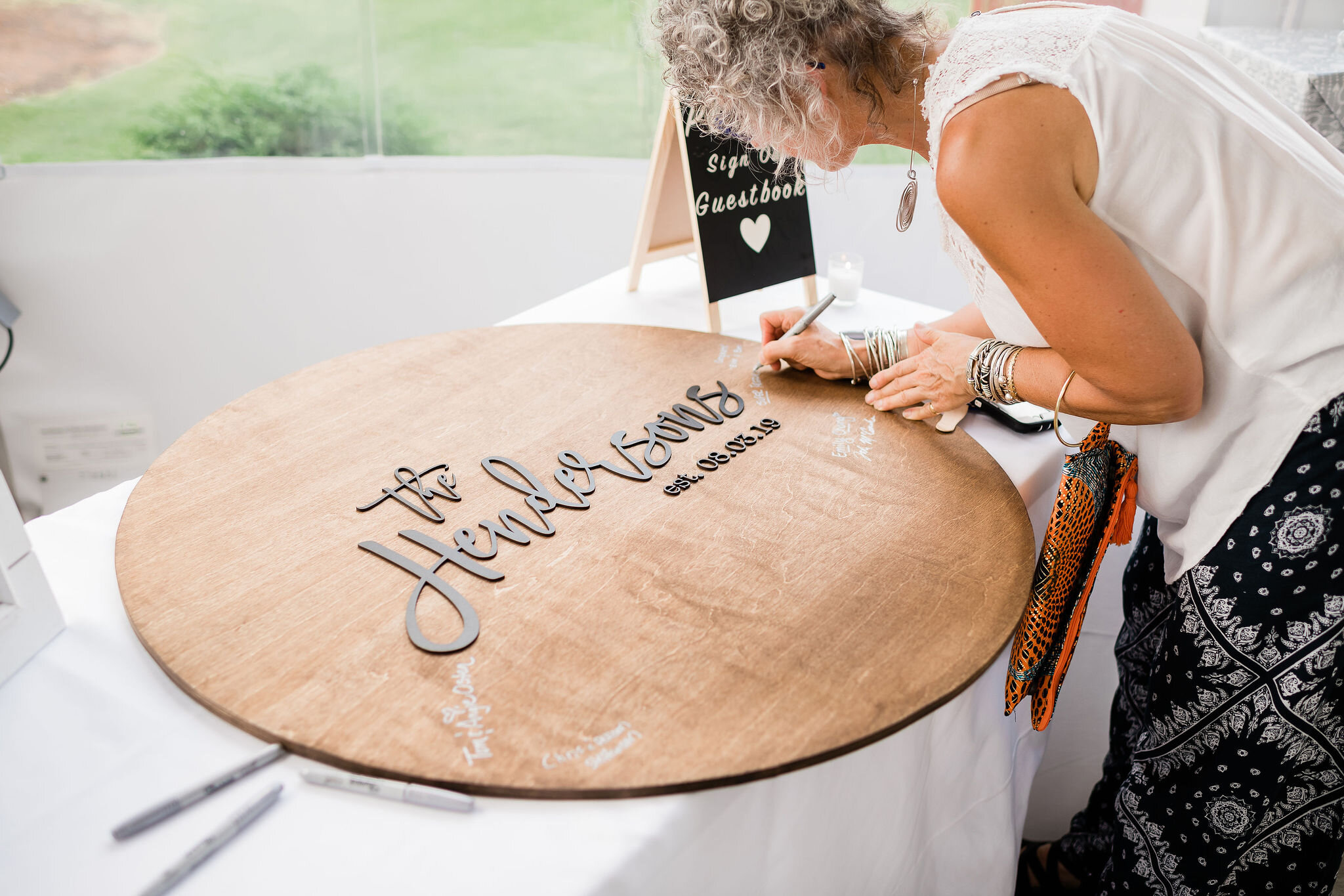 Wedding guest signing guest sign