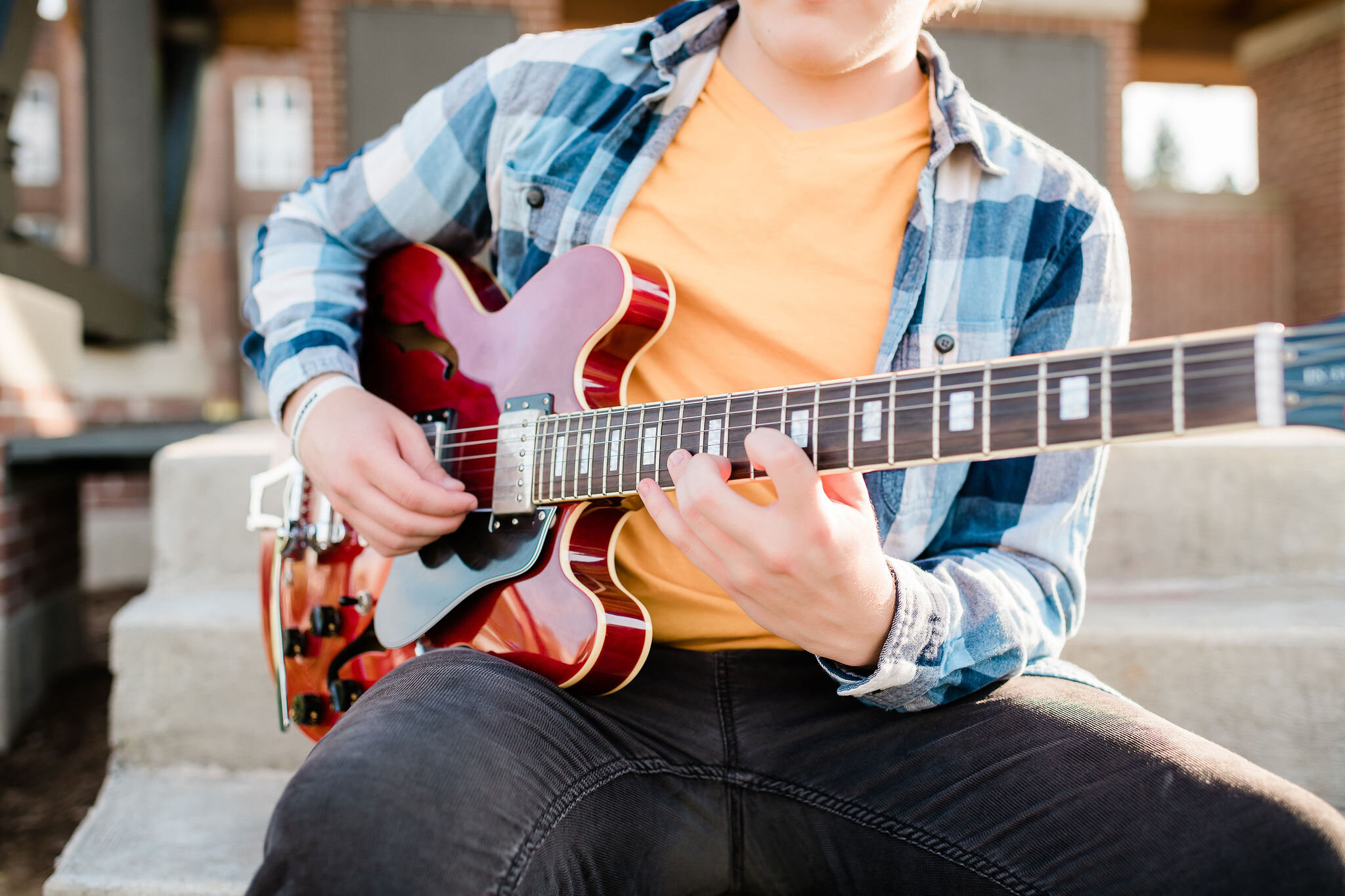 High school senior playing guitar