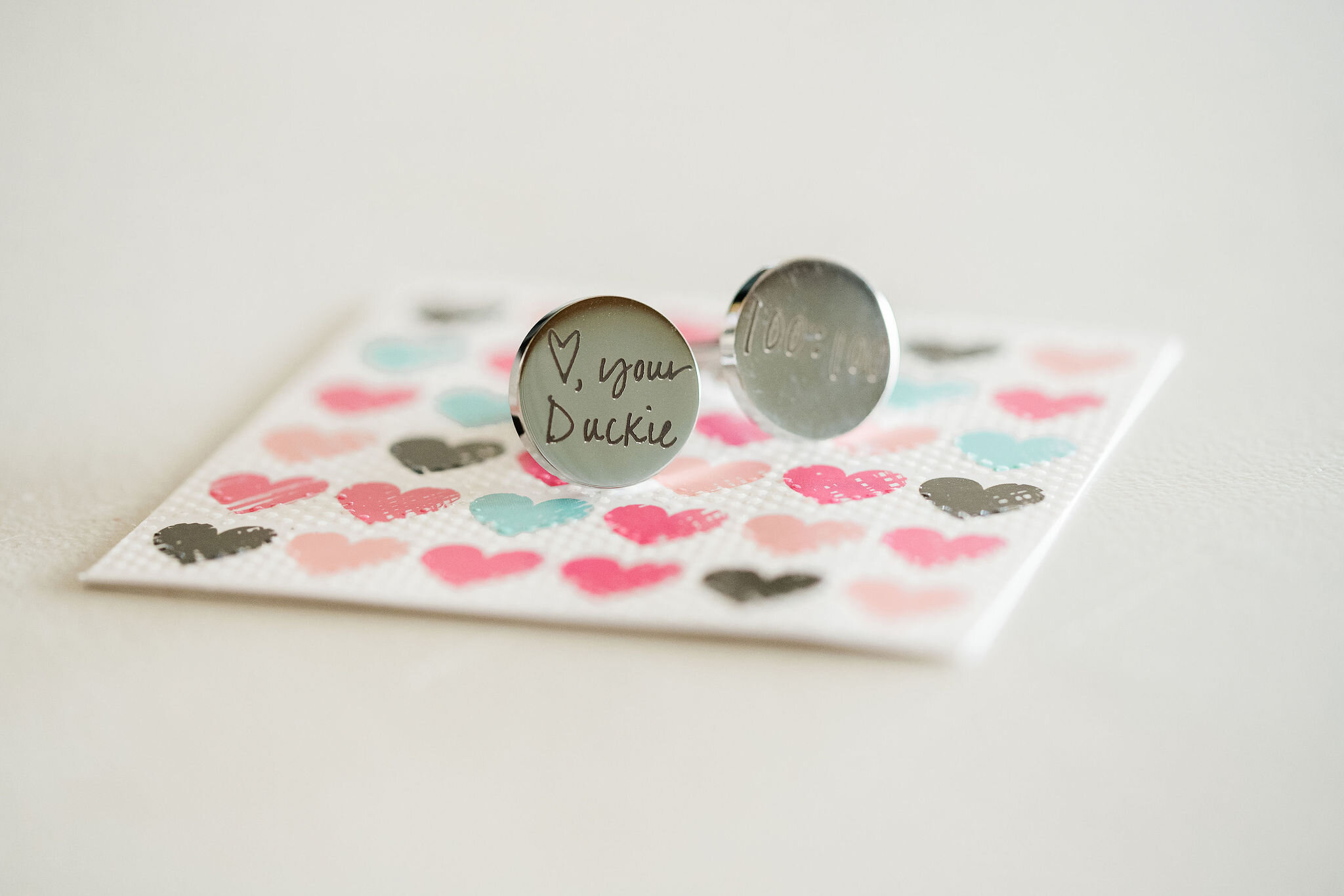 Personalized cufflinks on a card from the bride