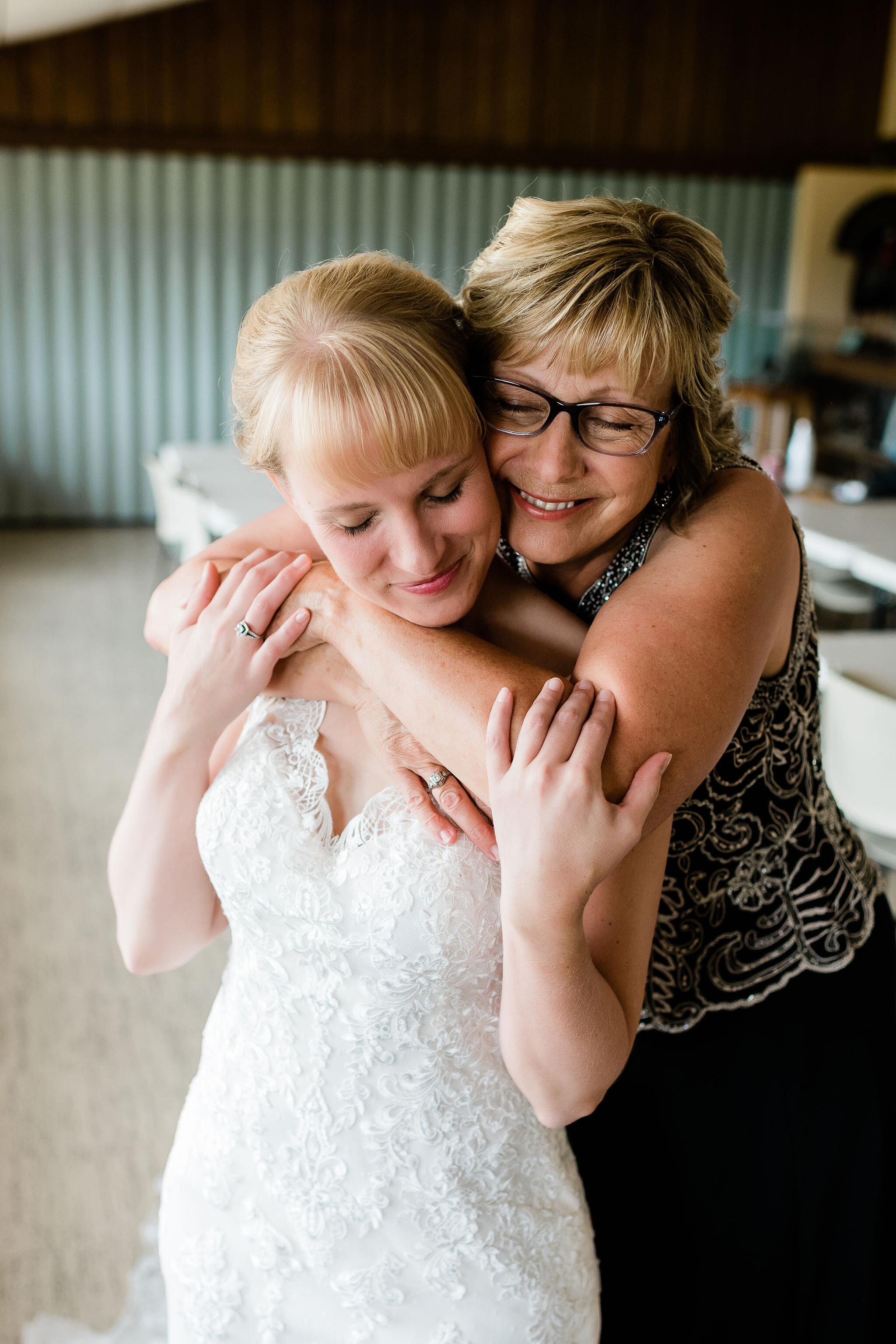 Mother of the bride hugging her daughter