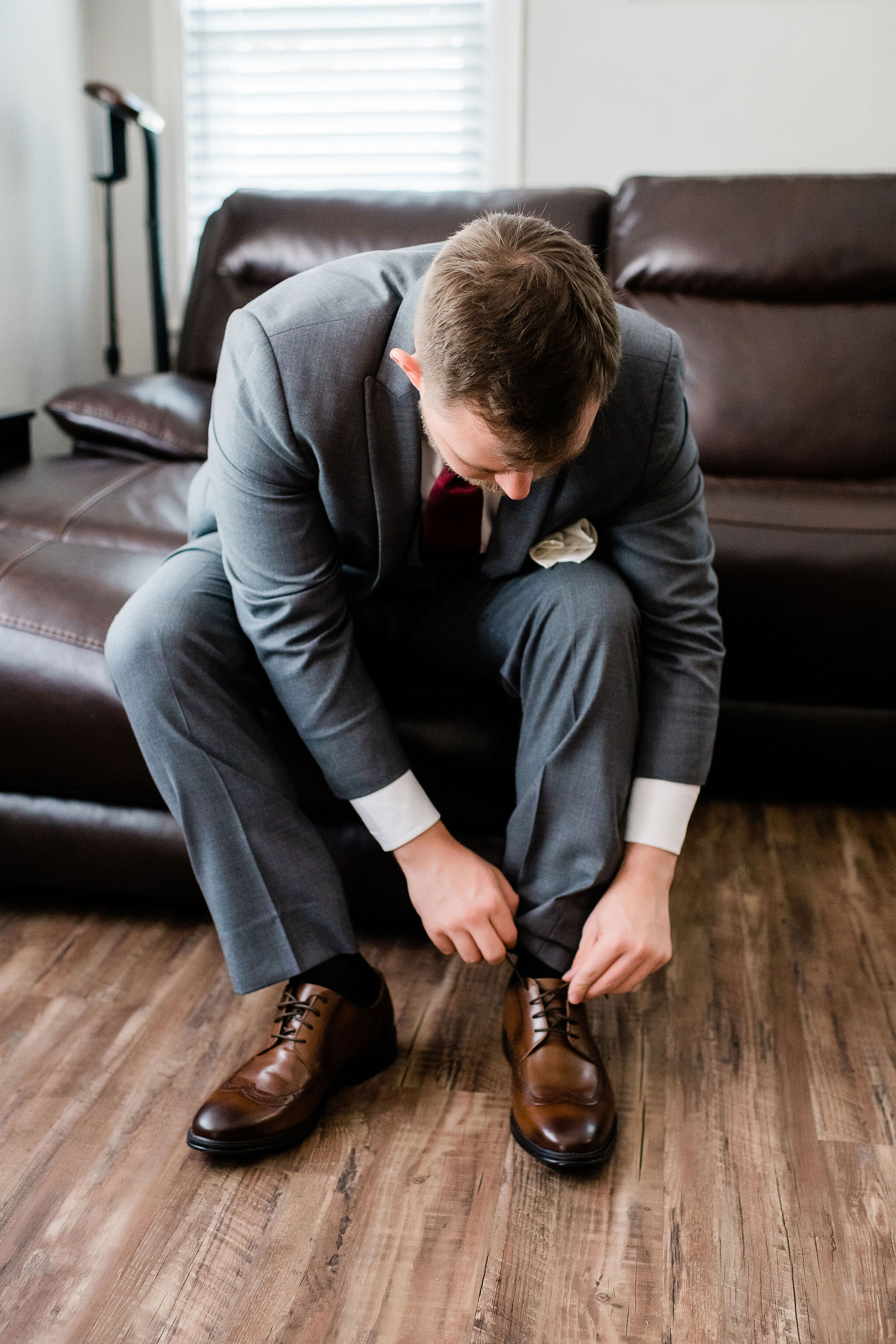 Groom tying his shoes