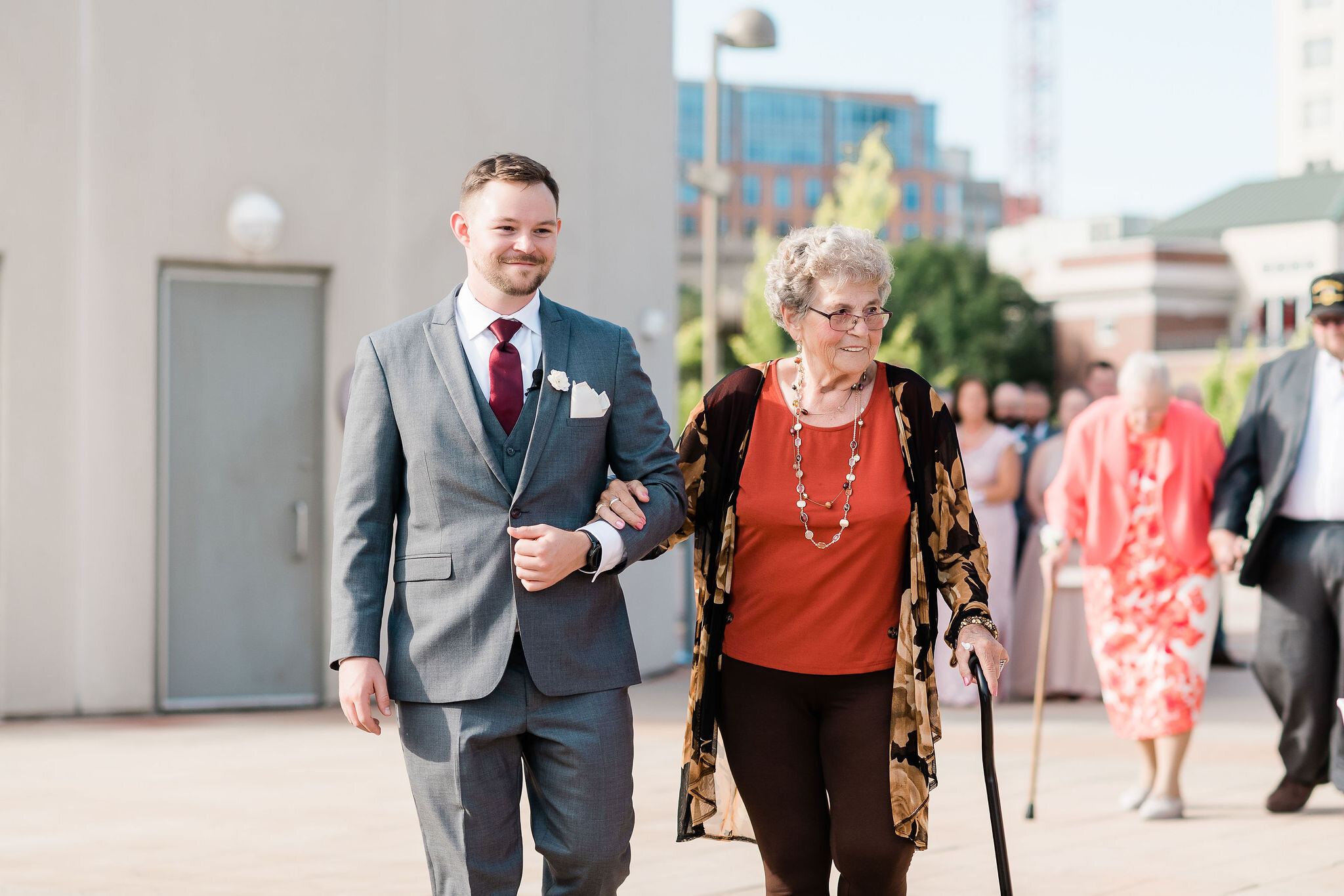 Groom and his grandmother walking down the aisle