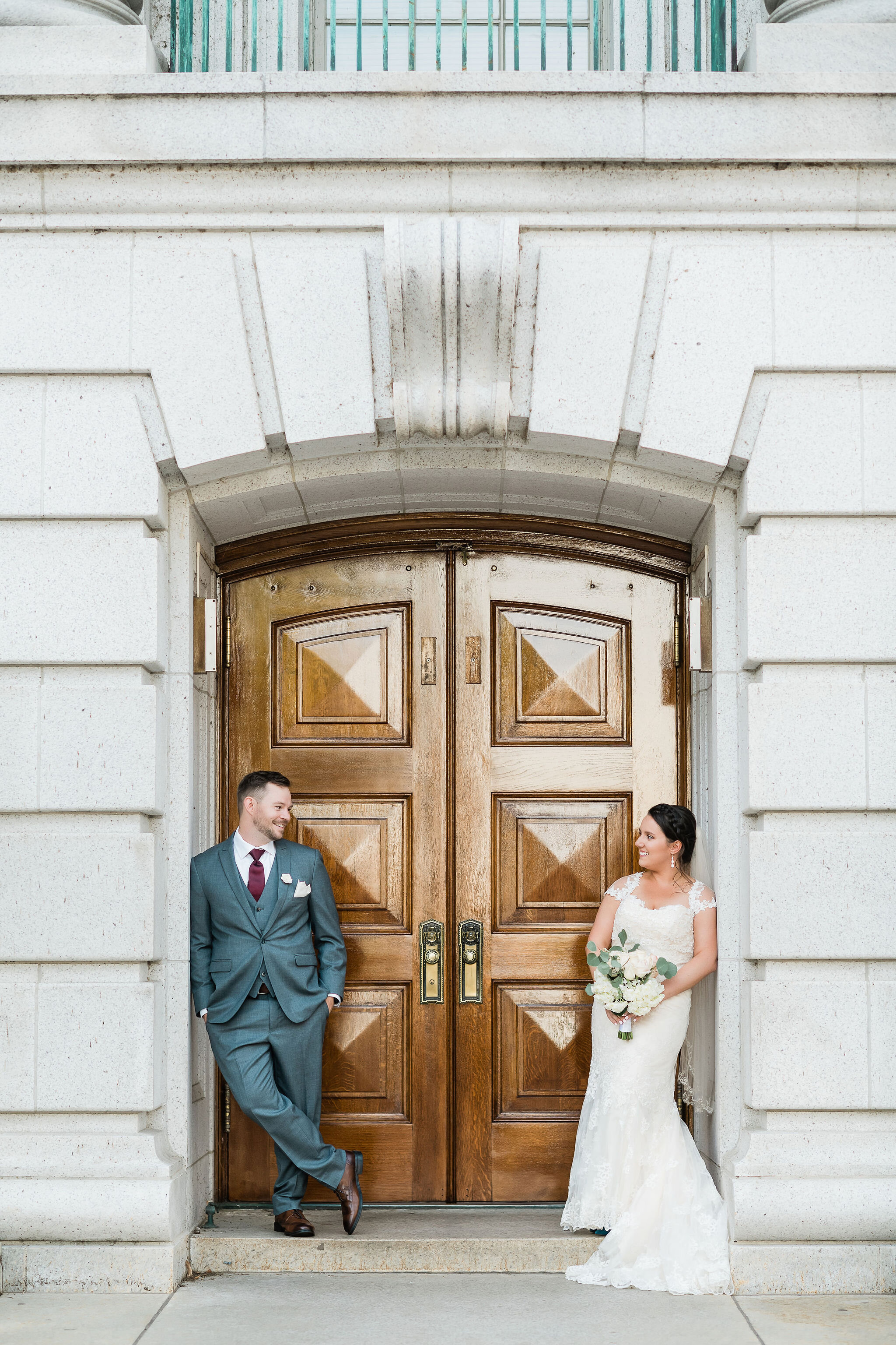 Bride and groom in a doorway looking at each other