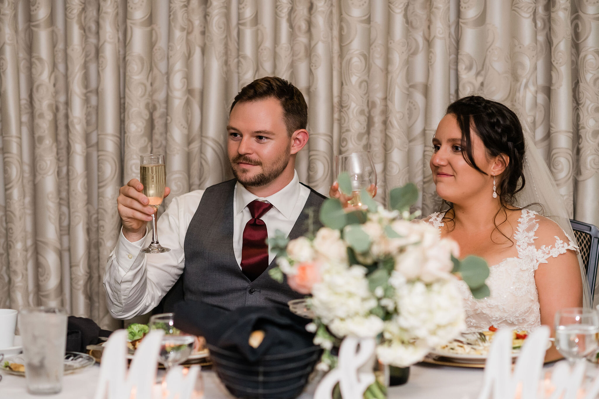 Bride and groom raising their glasses for a toast