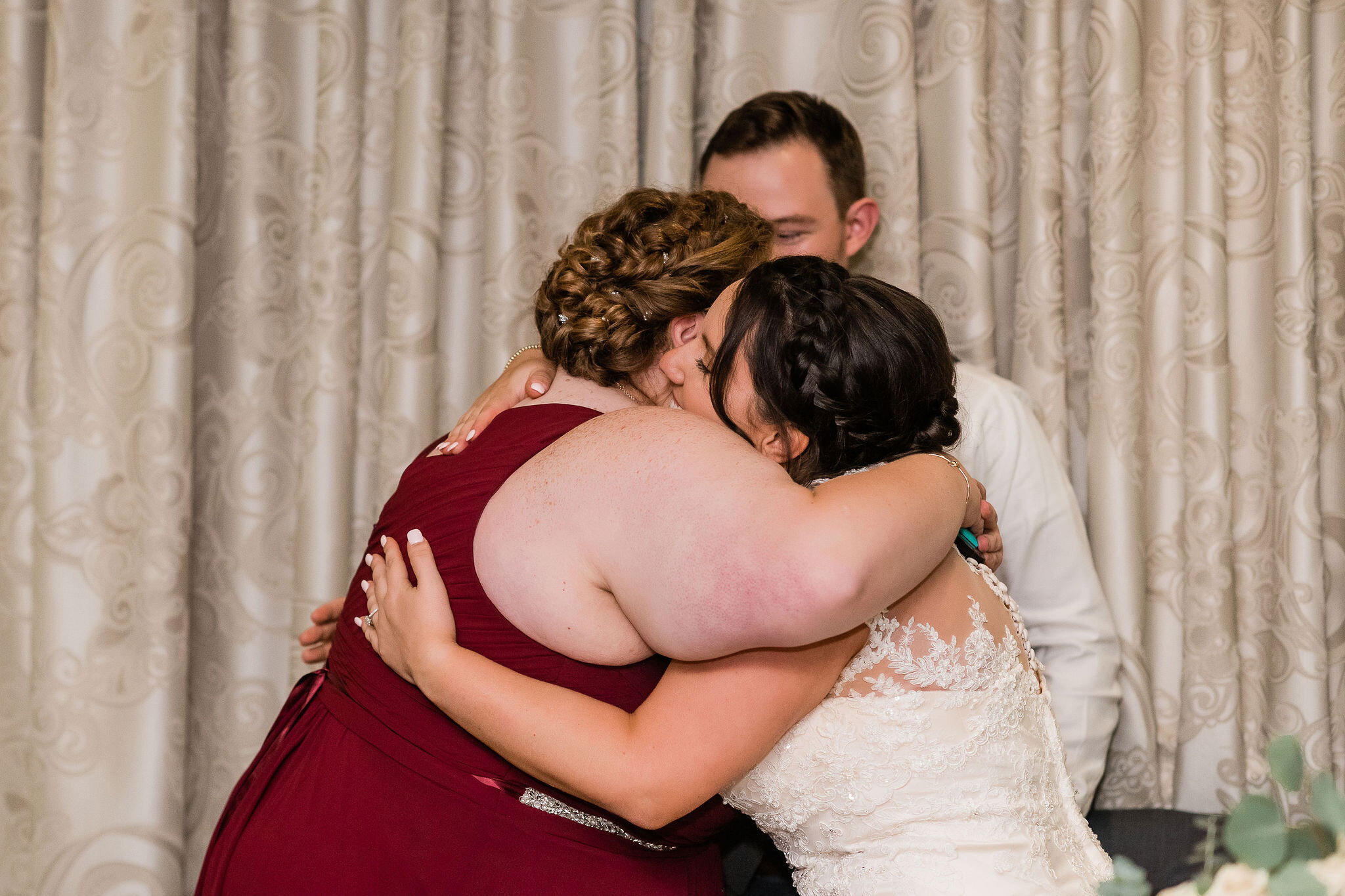 Bride hugging maid of honor