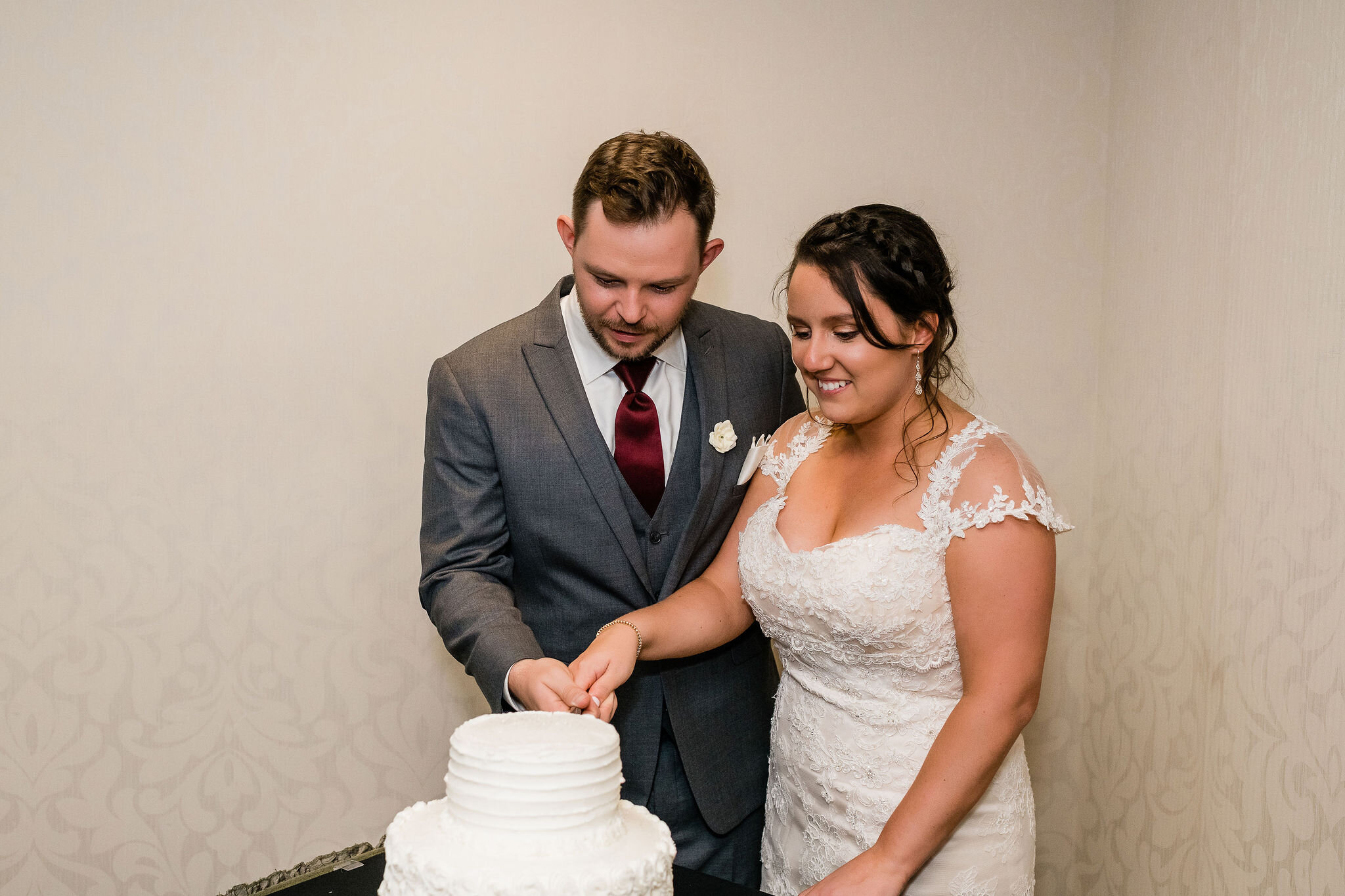 Bride and groom cutting cake