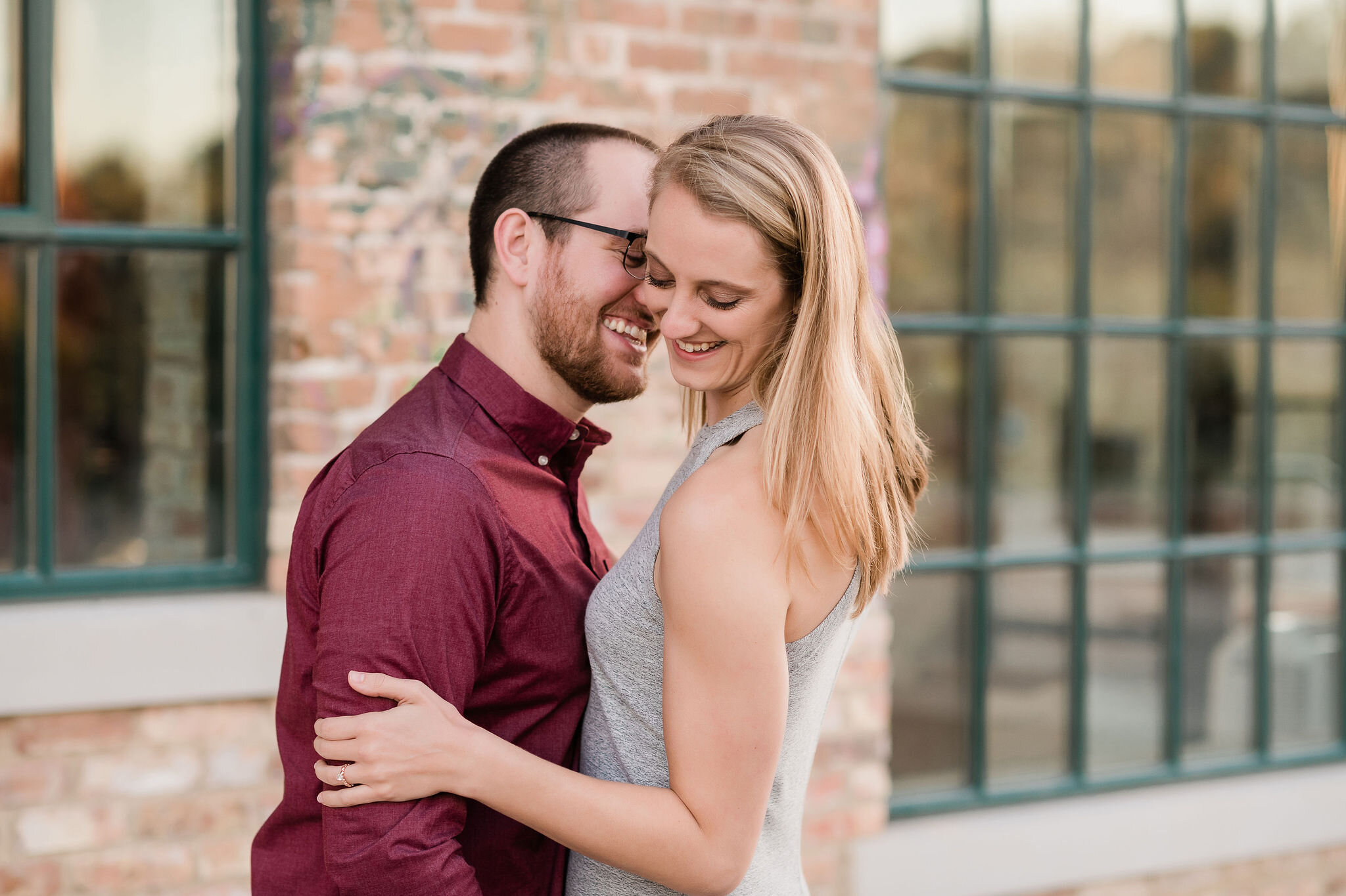 Man whispering in his fiancé's ear