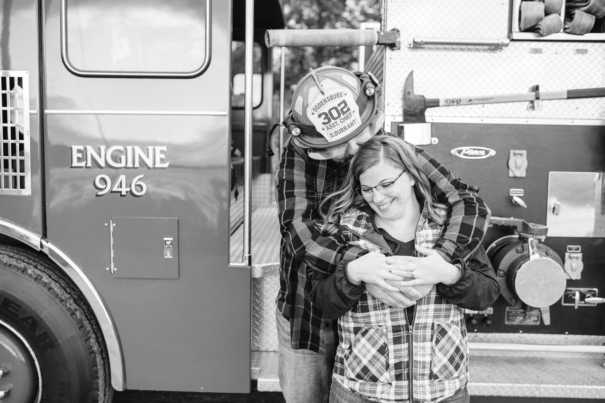 Engaged couple in front of a fire truck