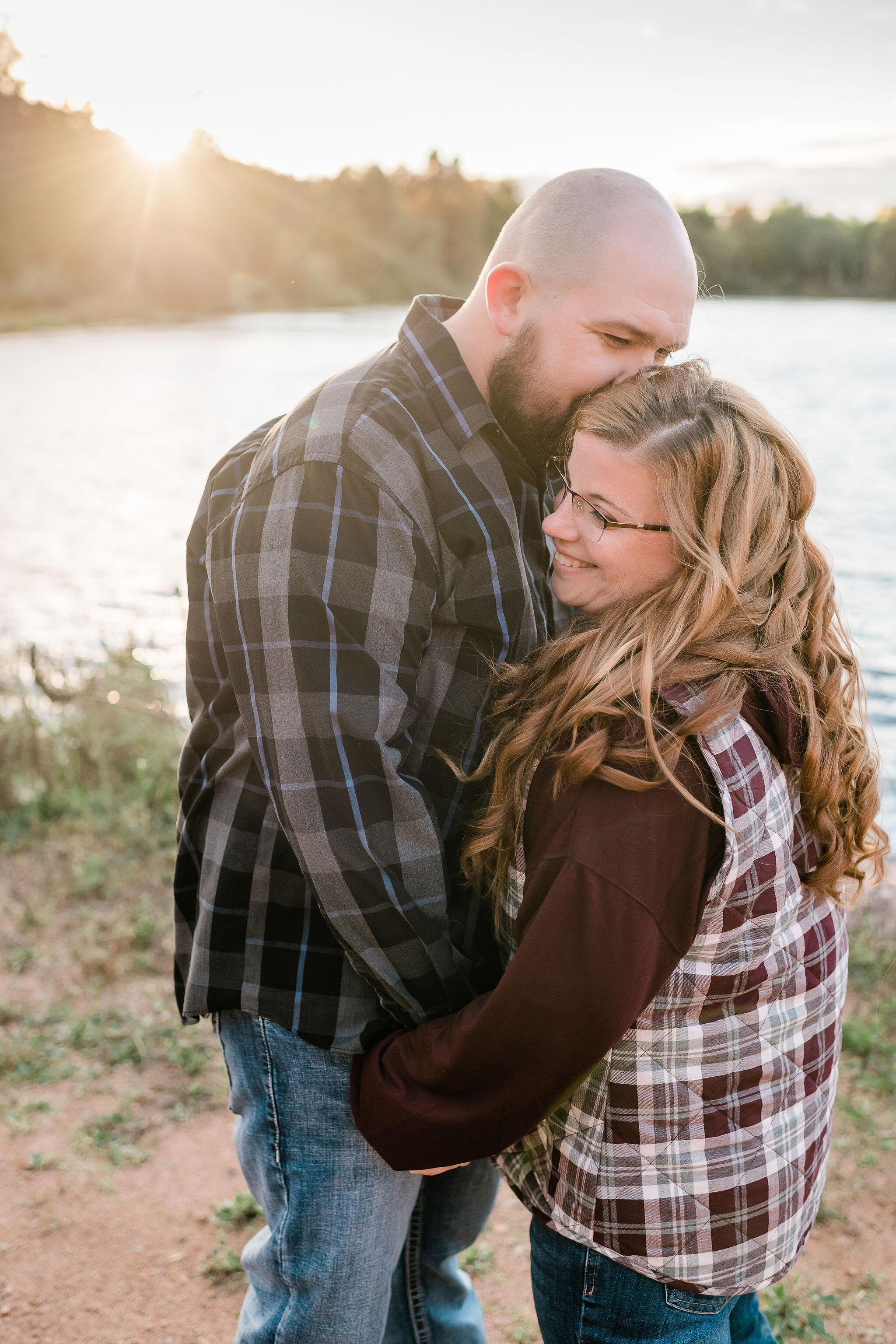 Man whispering into his fiancé's ear