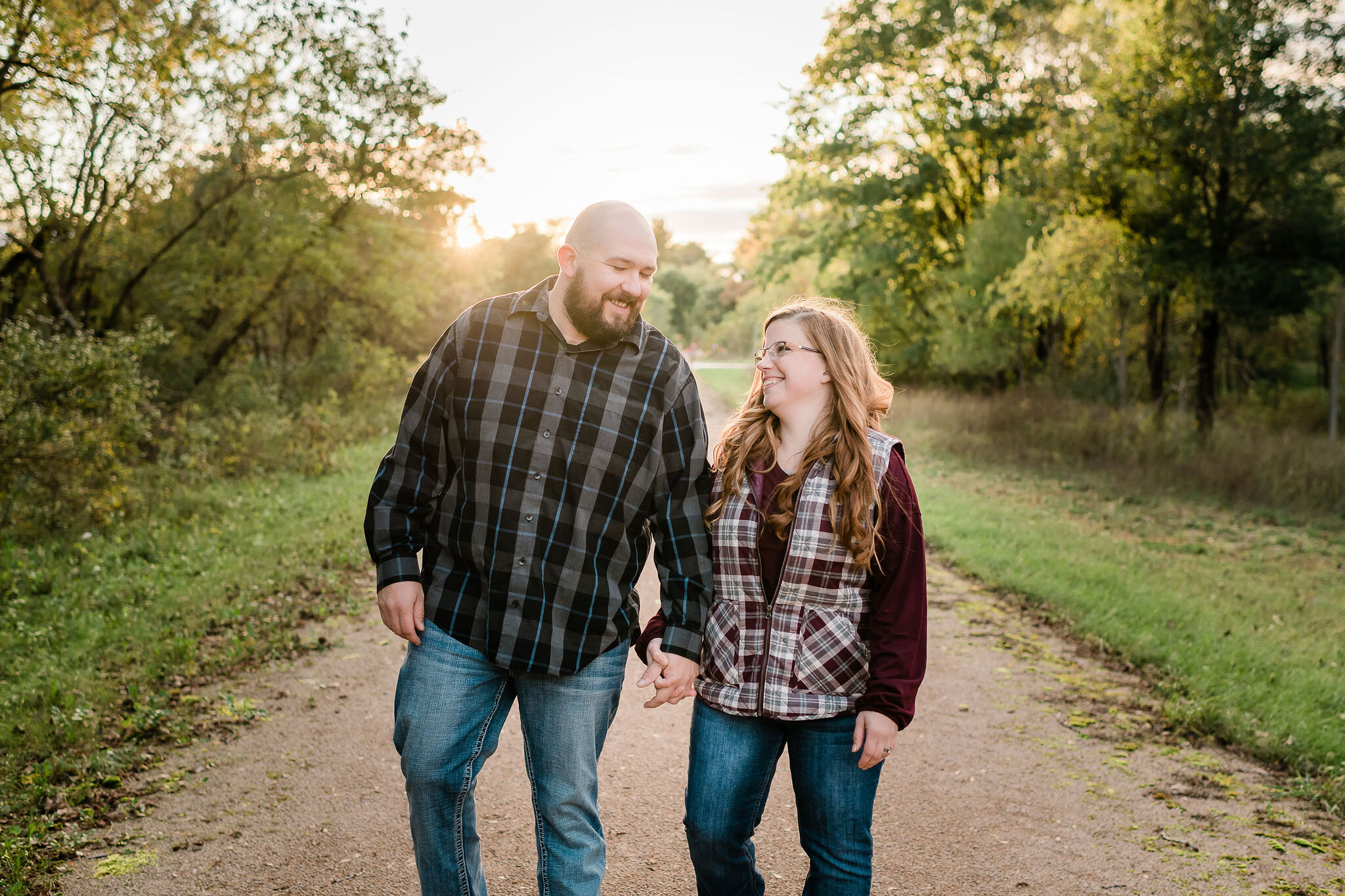 Engaged couple walking down a path