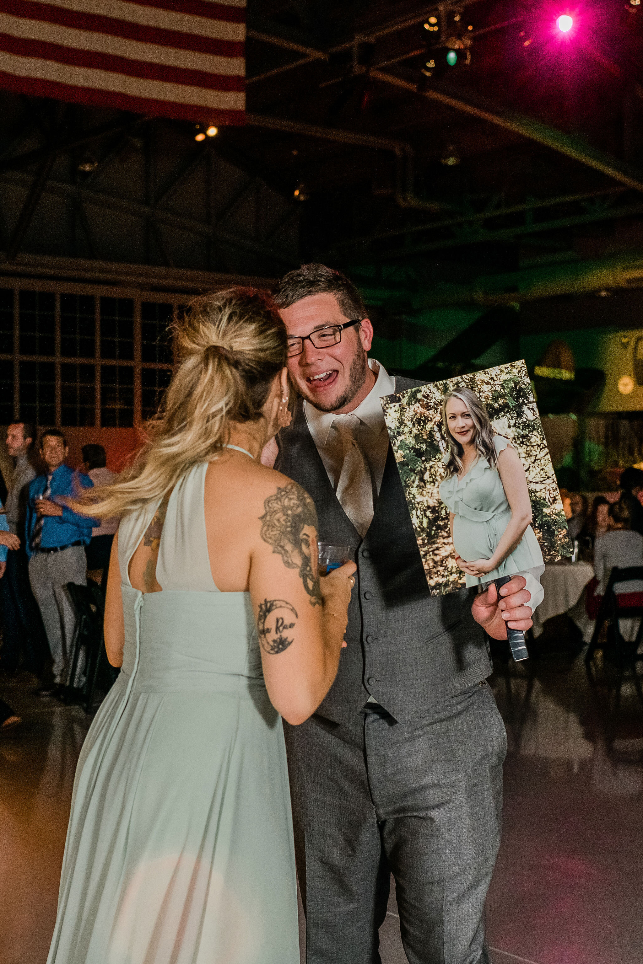 Wedding guests dancing with a photo of someone