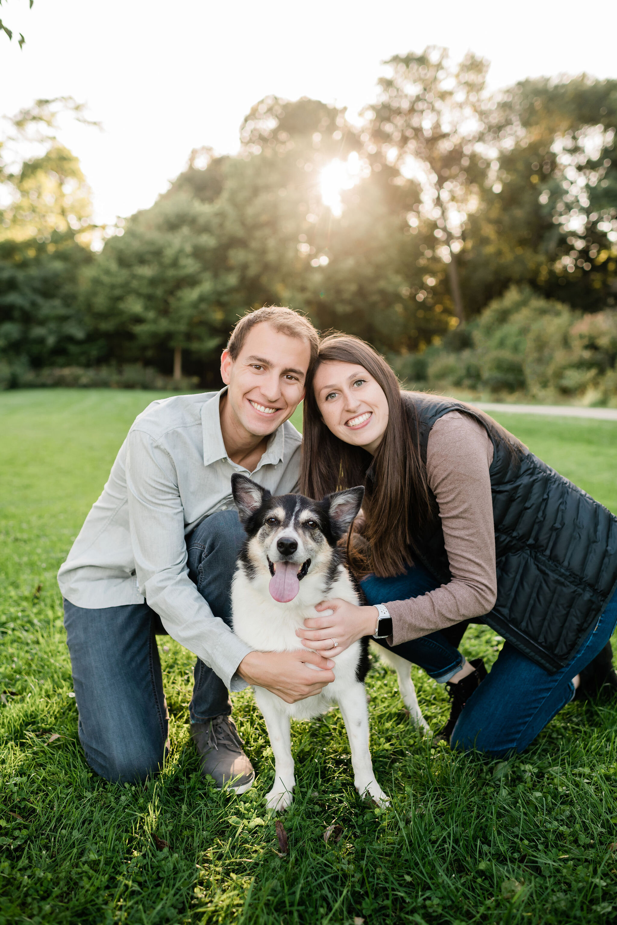 Engaged couple with their border collie