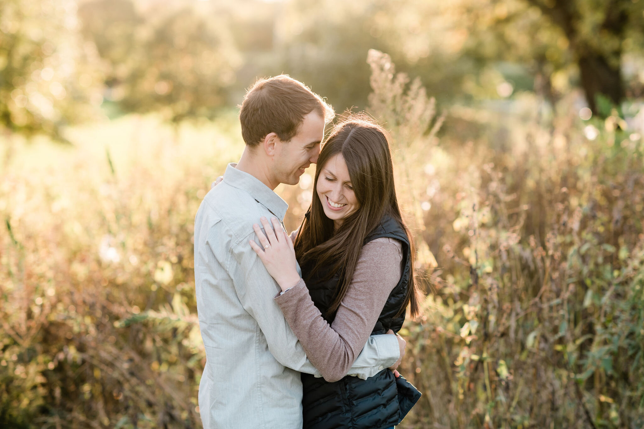 Man whispering into his fiancé's ear