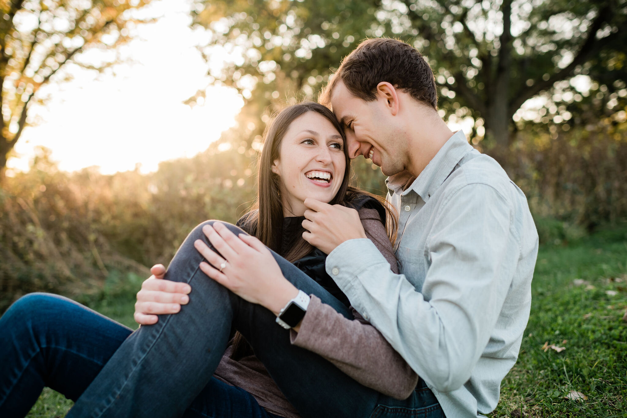 Engaged couple sitting and snuggling together