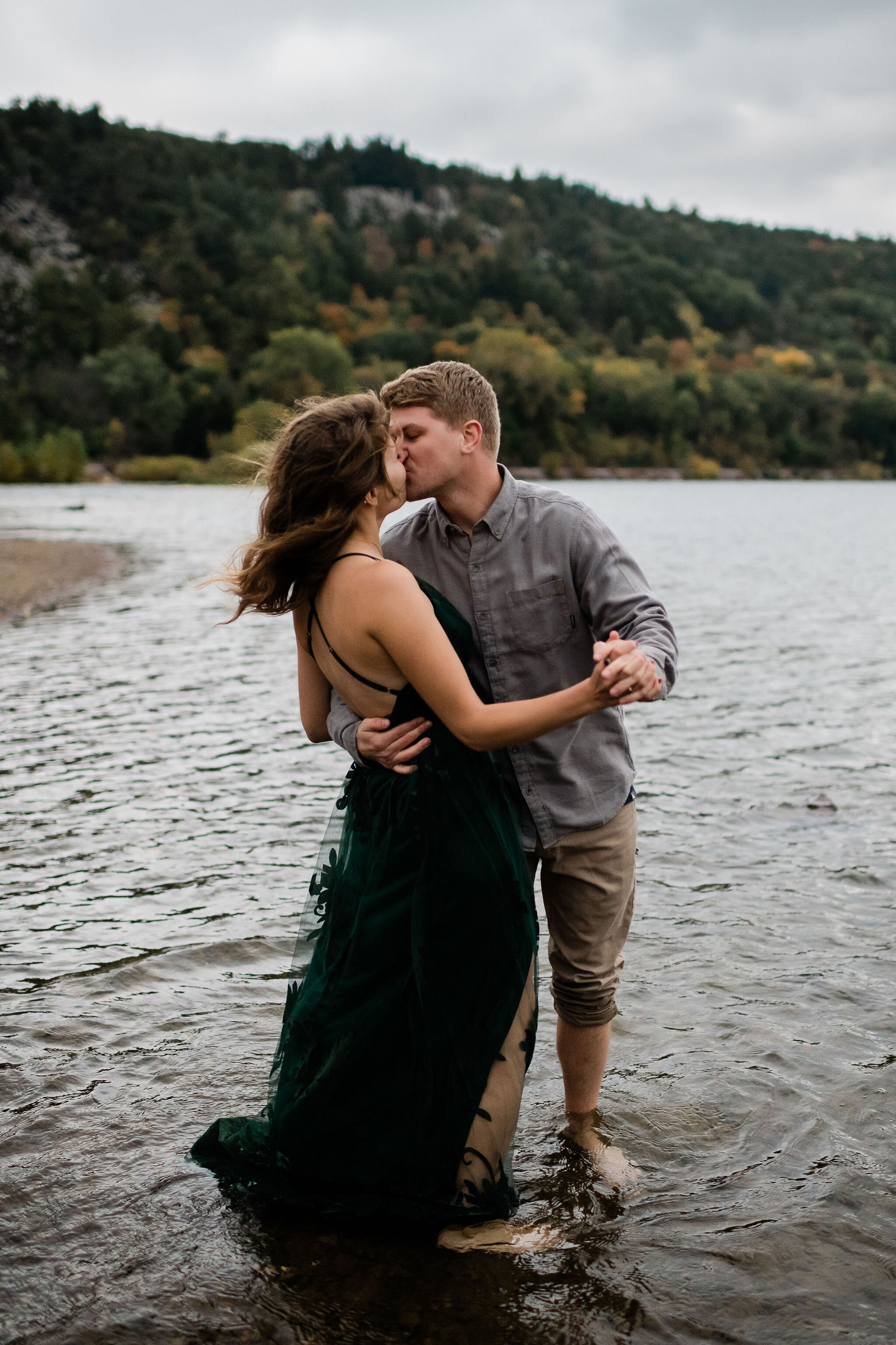 Engaged couple kissing in the water