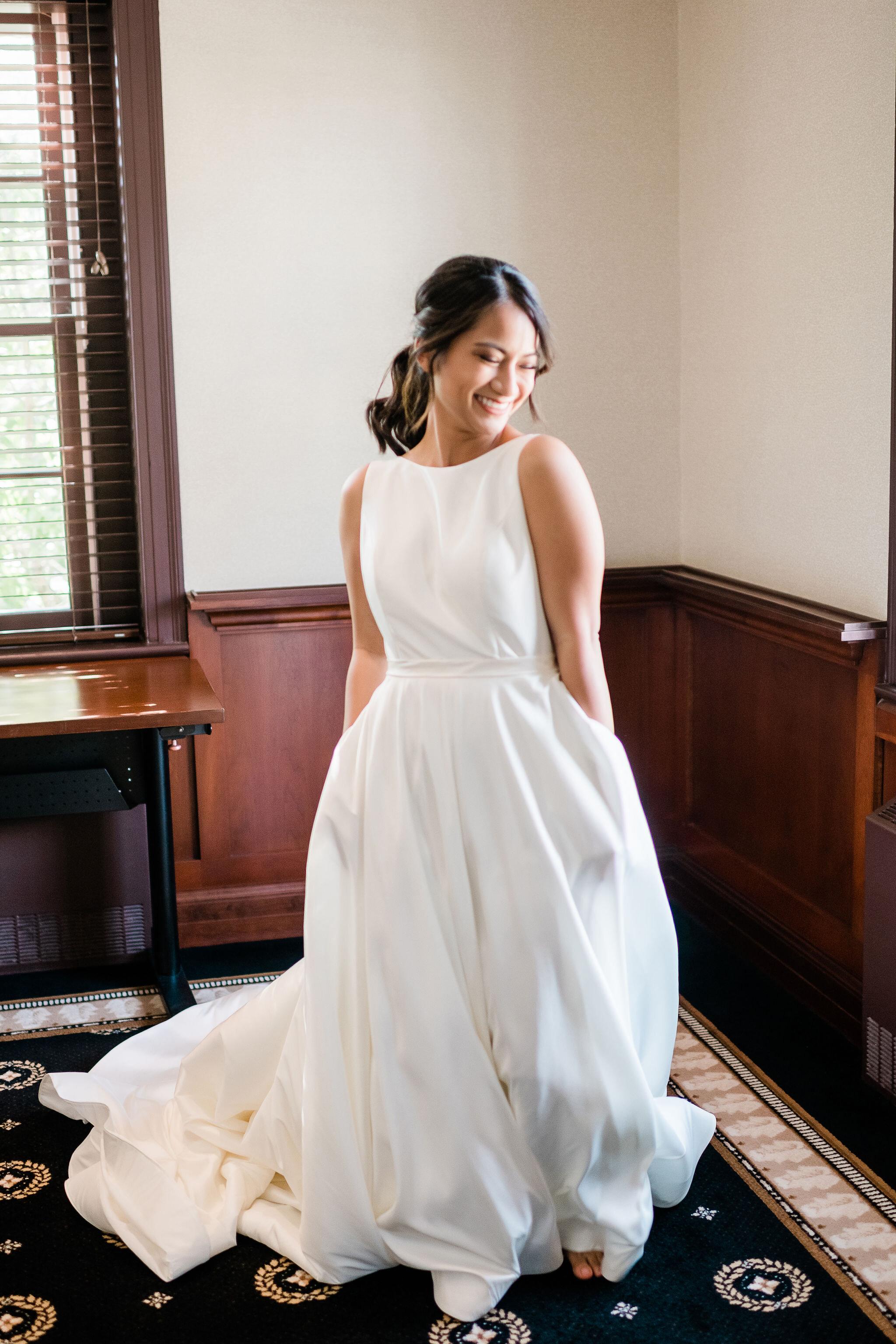 Bride swishing her wedding dress