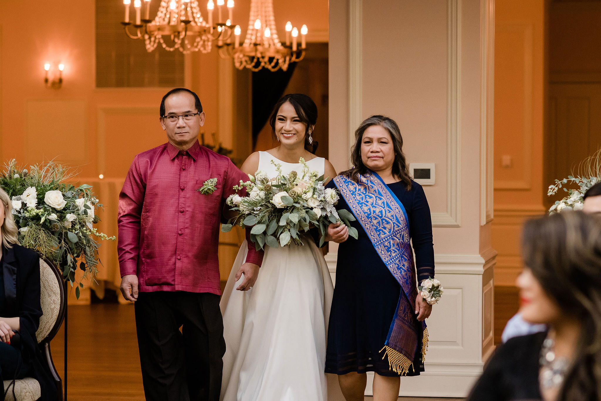 Bride walking down the aisle with her parents