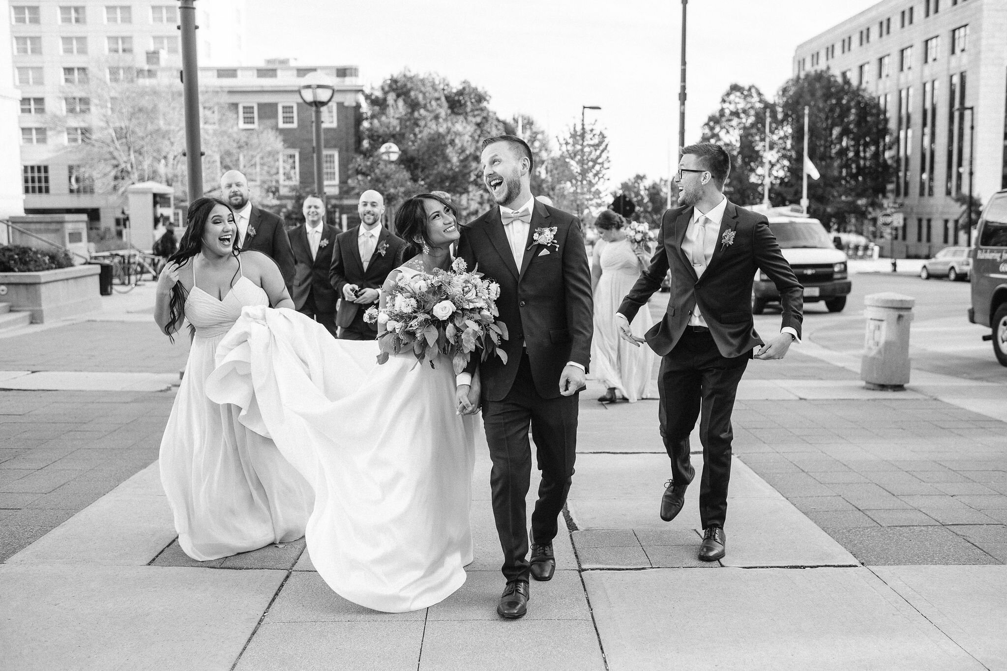 Wedding party walking down the sidewalk