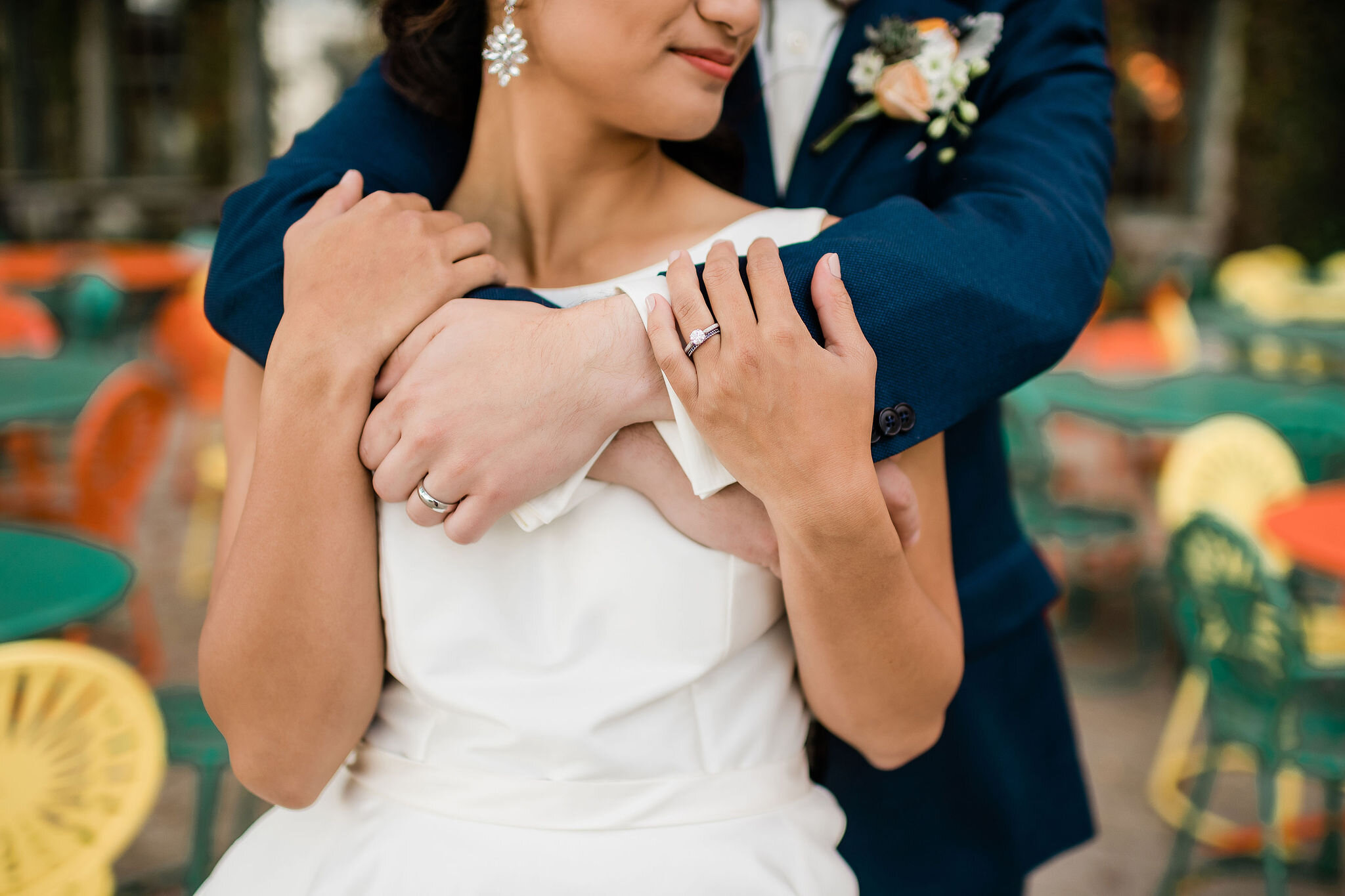 Groom wrapping his arms around bride