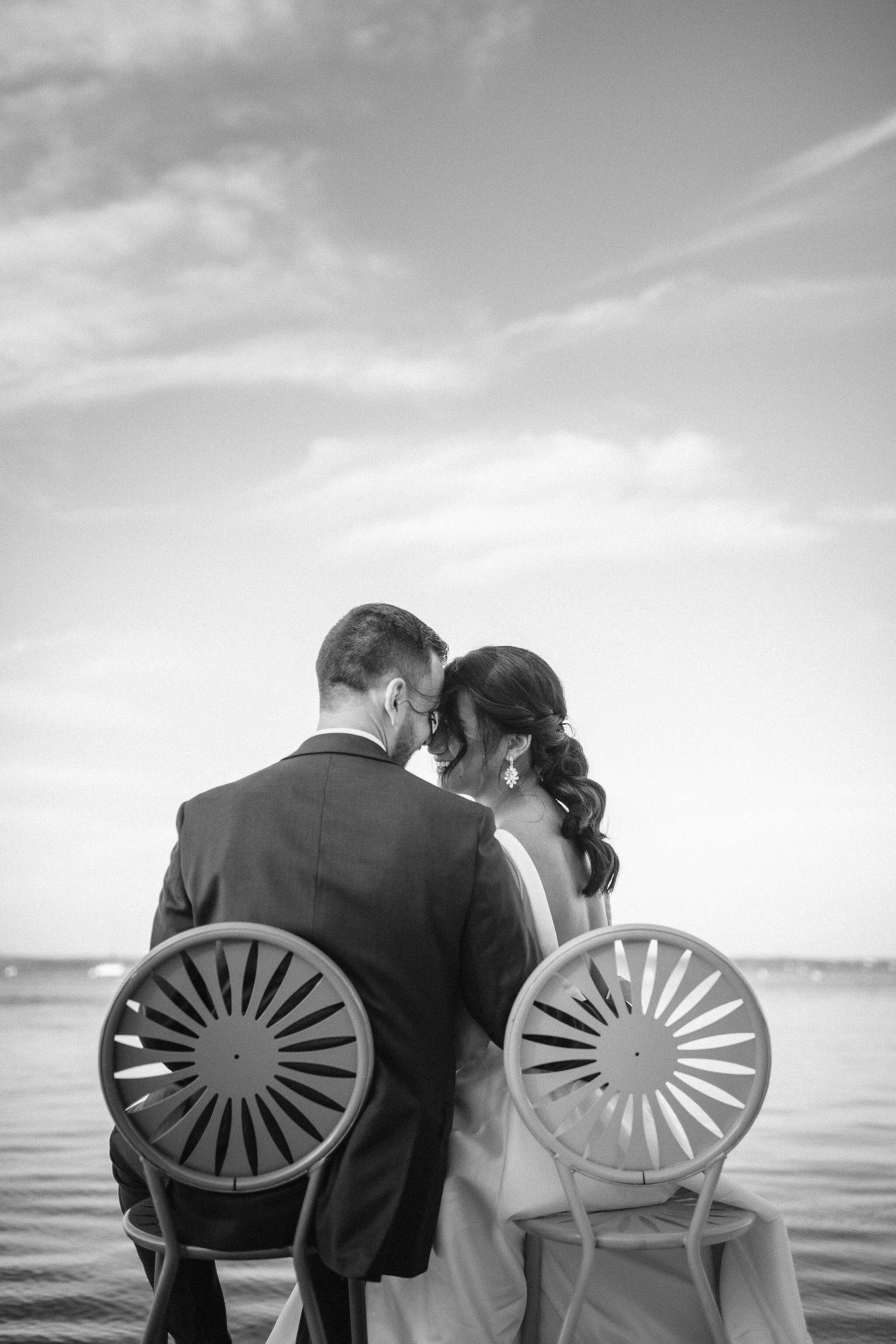 Bride and groom sitting on chairs at Memorial Union Terrace