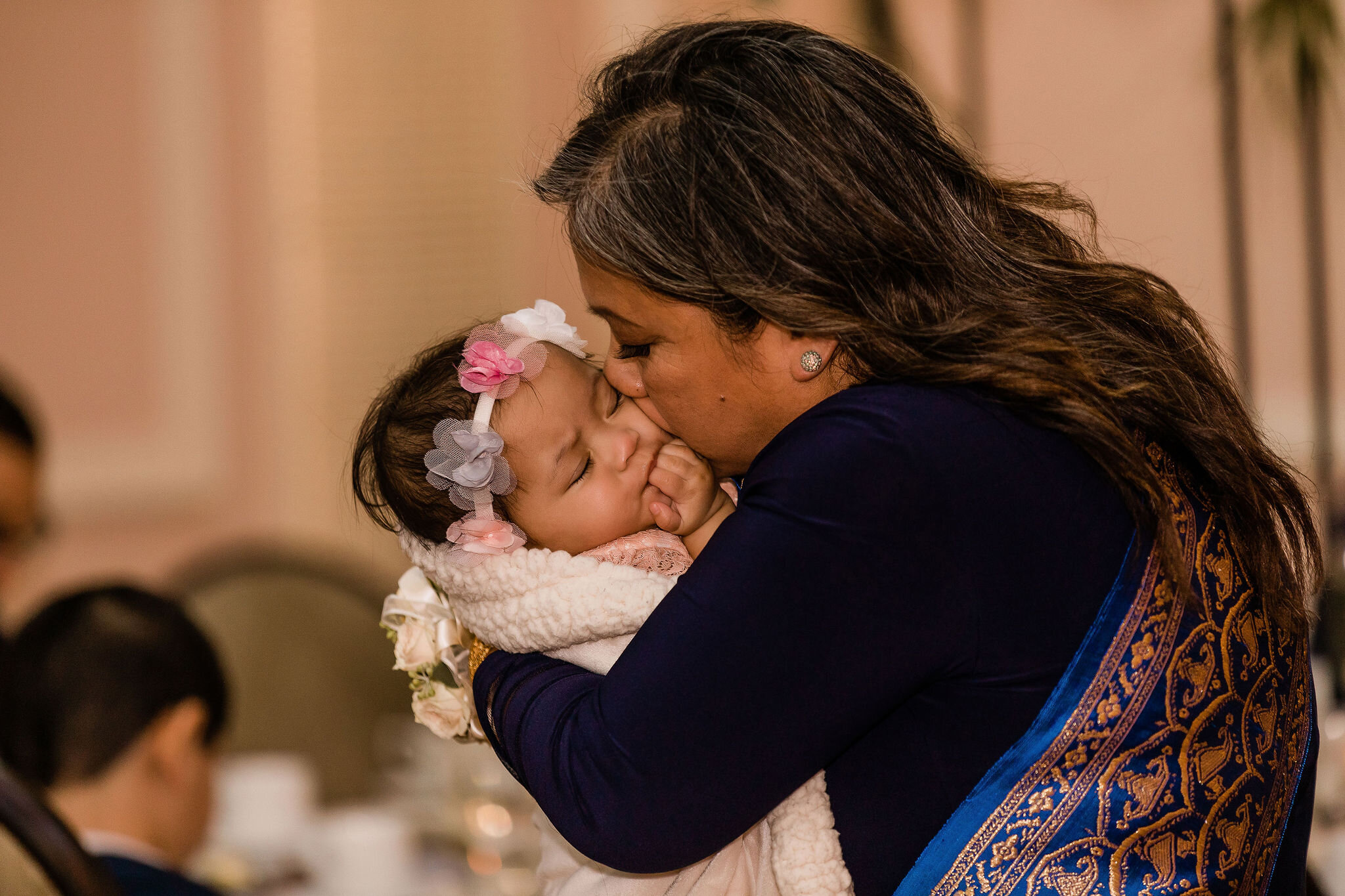 Mother of the bride kissing a baby