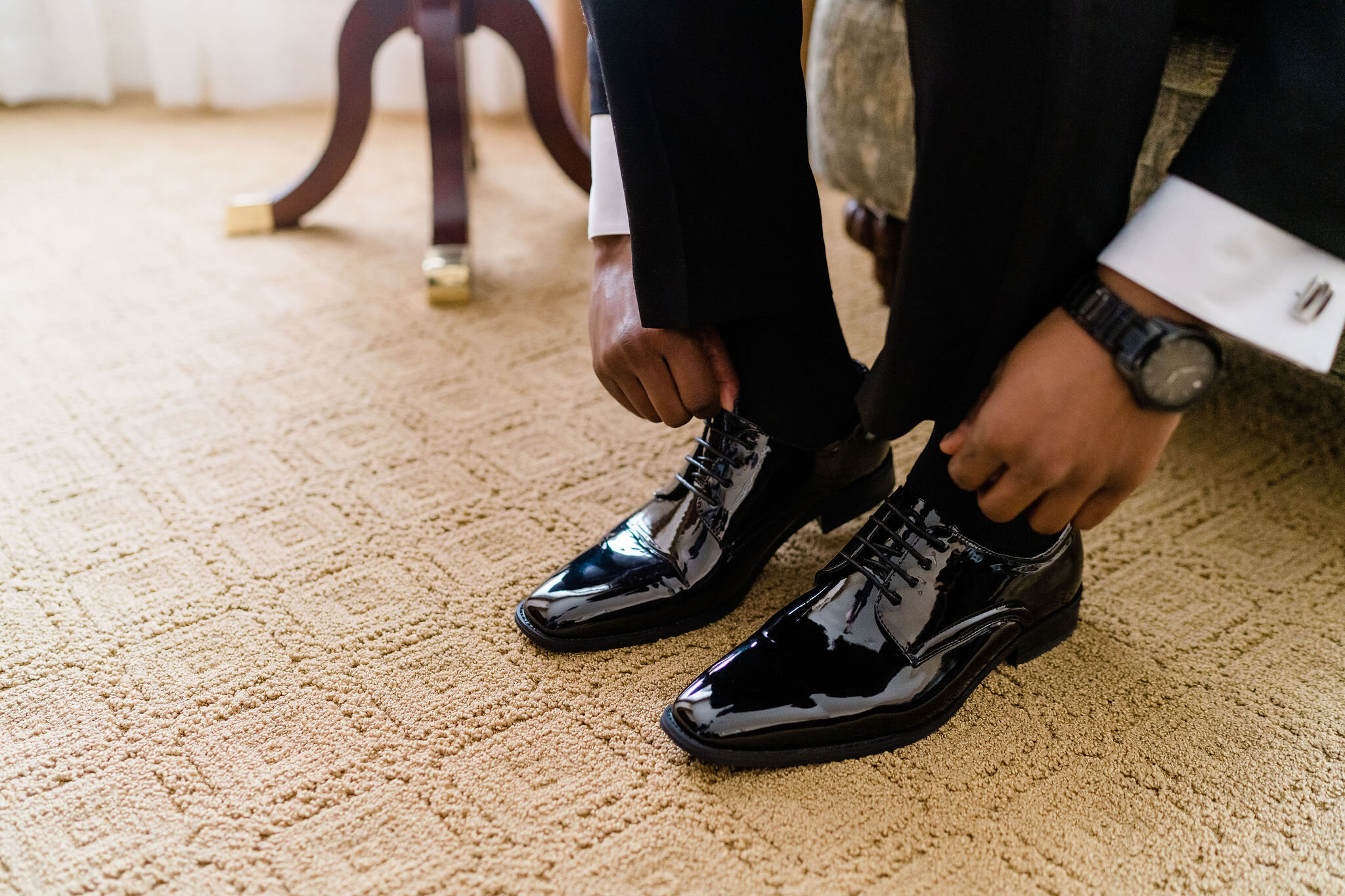 Groom putting his shoes on