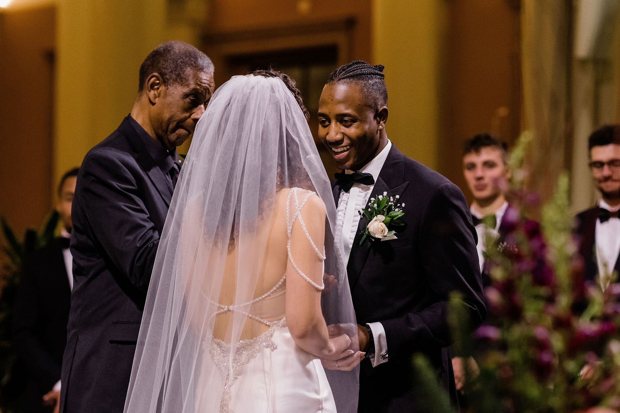 Groom smiling at bride