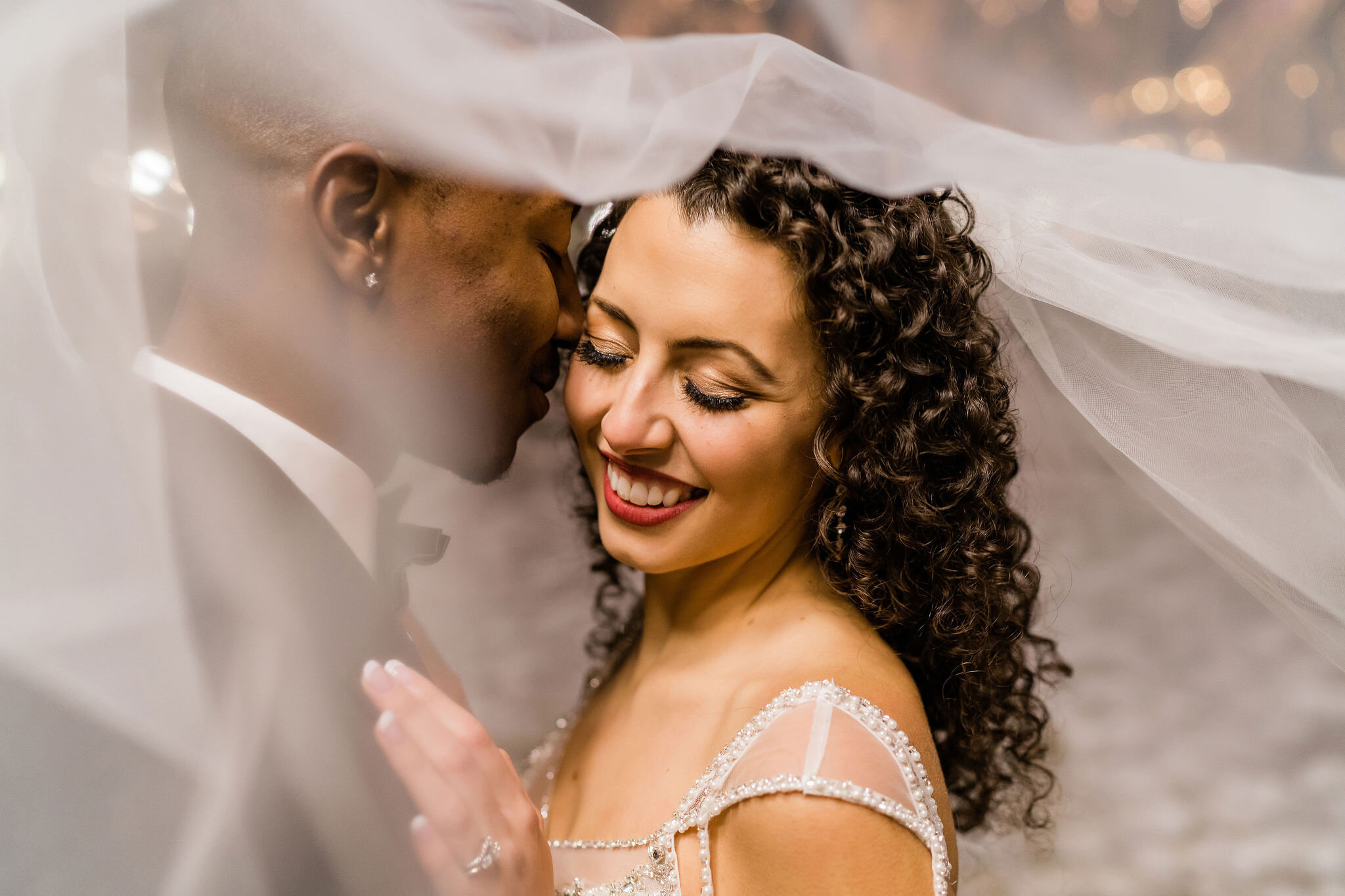 Bride and groom under her veil