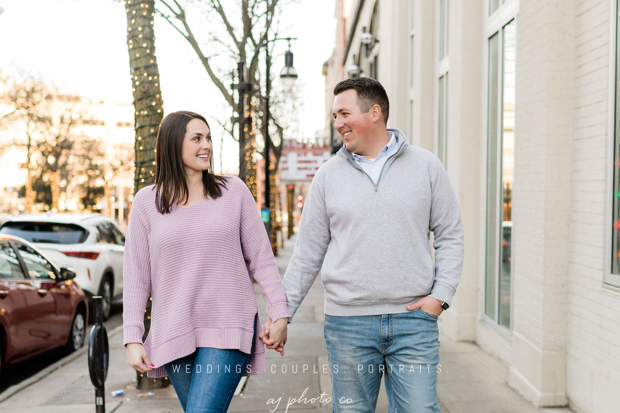 Engaged couple walking next to Lucille in Madison, WI