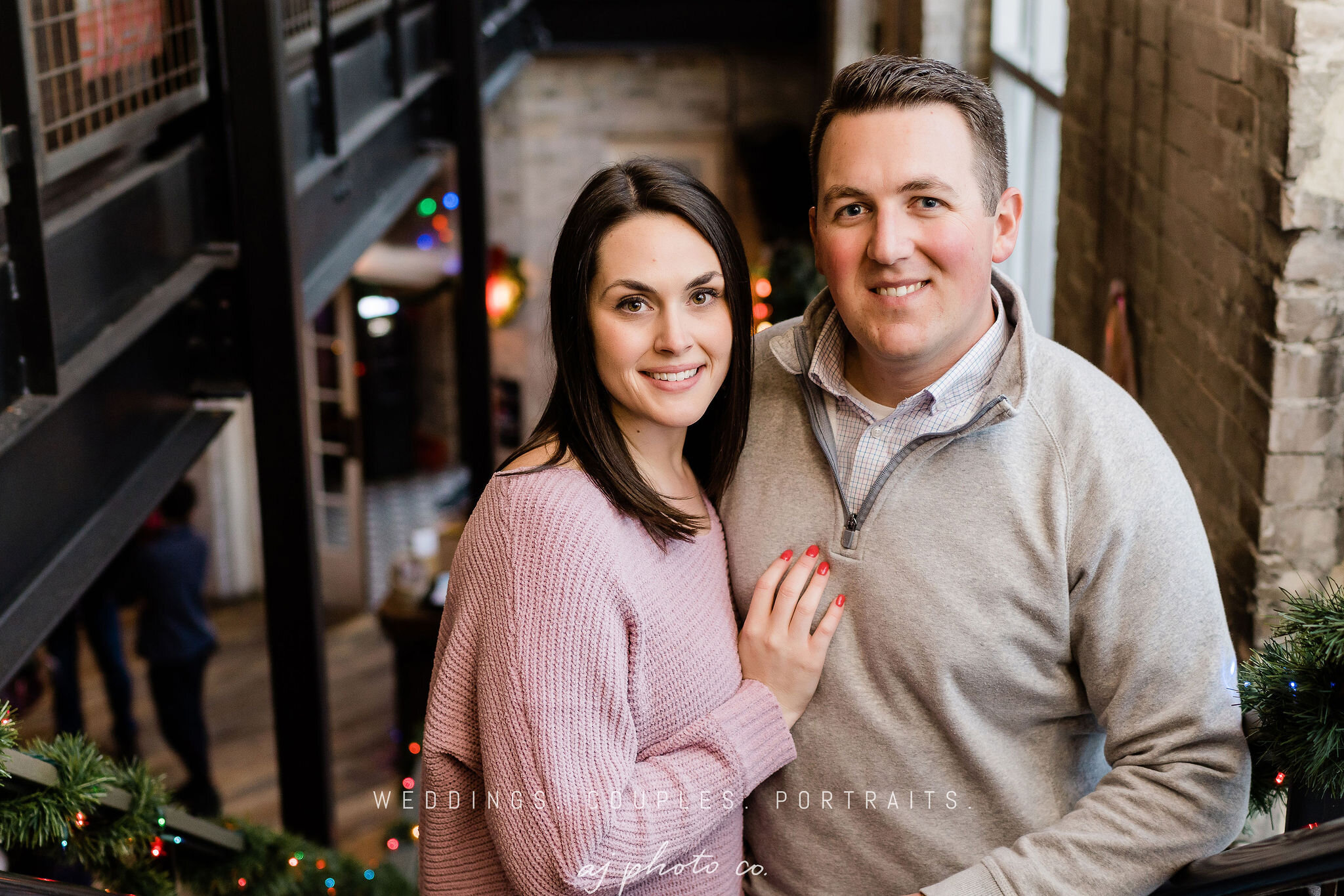 Engaged couple on the stairs inside Lucille in Madison, WI