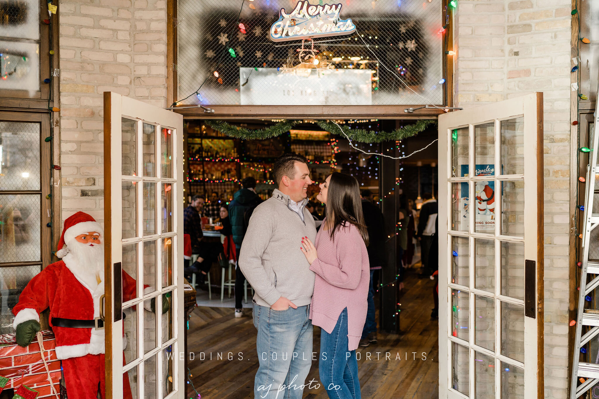 Engaged couple in the entrance of Lucile in Madison, WI