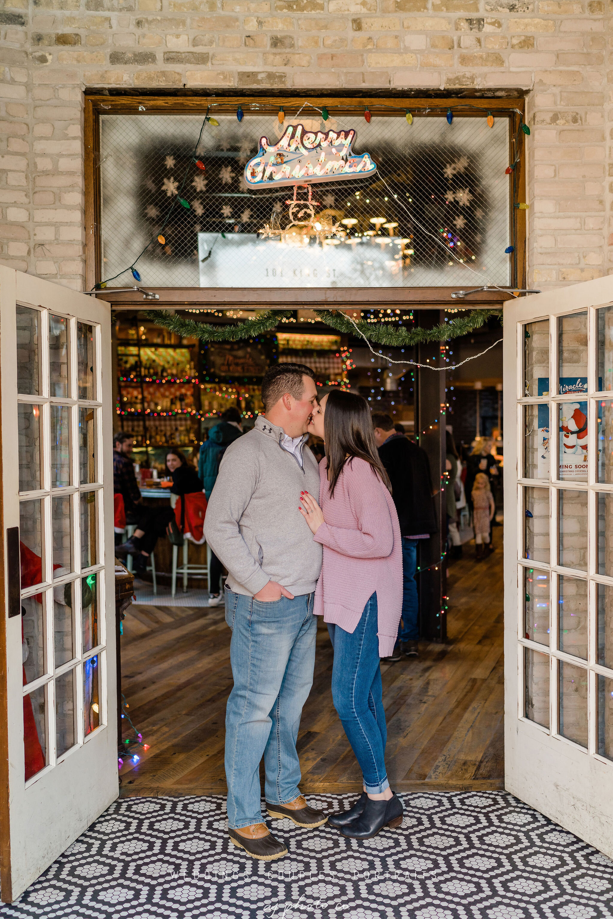 Engaged couple in the entrance of Lucile in Madison, WI