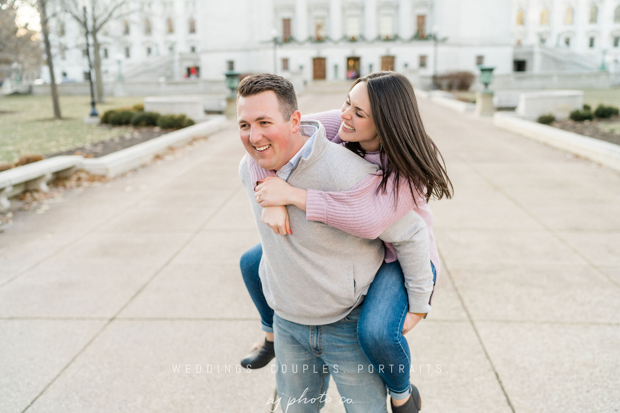 Man giving his fiancé a piggyback ride